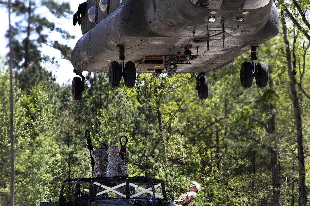 Soldiers prepare to hookup a Humvee to a CH-47D Chinook helicopter during slingload training at Clarks Hill Training Site at Plum Branch, South Carolina, April 2, 2016. South Carolina Army National Guard photo by Capt. Brian Hare