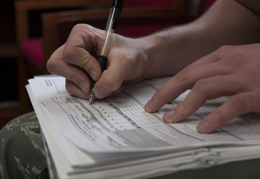 U.S. Air Force Airman 1st Class Myles Meza, 733rd Air Mobility Squadron joint inspection manager, prepares paperwork for a joint inspection April 7, 2016, at Kadena Air Base, Japan. This paperwork ensured that the cargo to be inspected was properly logged. (U.S. Air Force photo by Airman 1st Class Lynette M. Rolen/Released) 