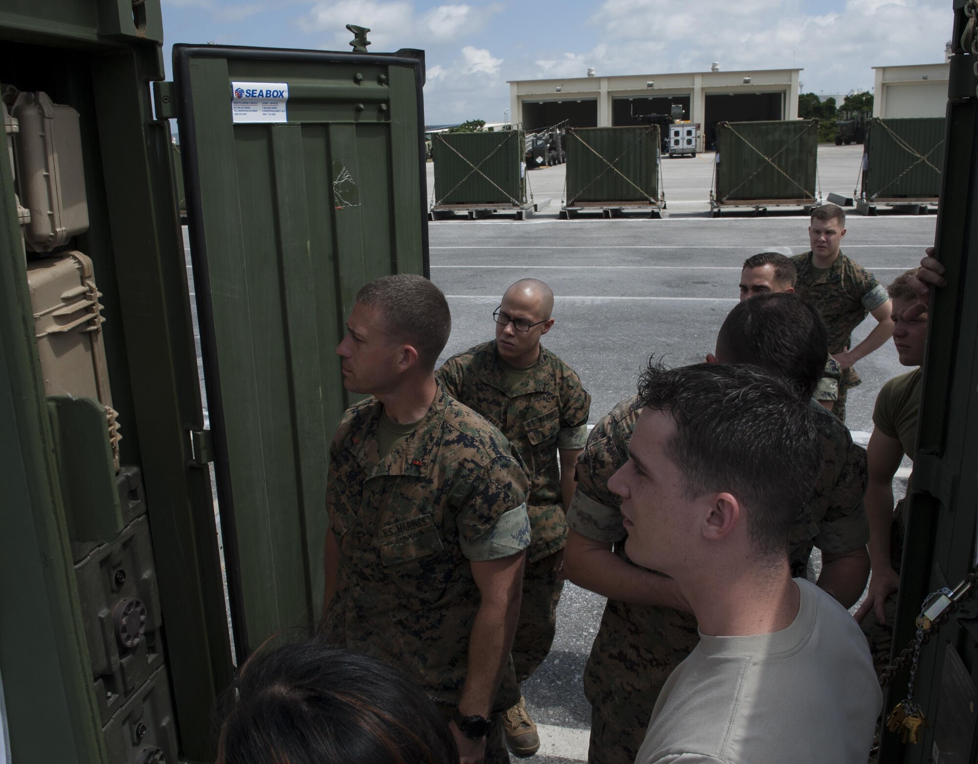 U.S. Marine Corps Warrant Officer Matthew Langlois, 4th Marine Regiment, 3rd Marine Division mobility officer, discusses cargo specifications with members of a joint inspection team April 7, 2016, at Kadena Air Base, Japan. Although Marine and Air Force load rules and regulations differ, this team was able to work together and carry out the inspection. Prior to going on Air Force aircraft, the inspection needs to take place to ensure the cargo is at Air Force standards. (U.S. Air Force photo by Airman 1st Class Lynette M. Rolen/Released)