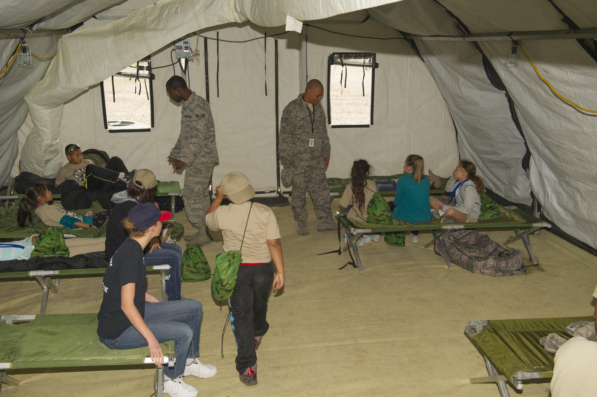 Children listen to a briefing about living out of tents during Operation K.I.D. (Kids Investigating Deployment), April 8 at Holloman Air Force Base, N.M. Each year, the Airmen and Family Readiness Center and the Youth Center host Operation K.I.D. in April, the Month of the Military Child. The A&FRC believes that it is important for children to experience what their parents go through during a deployment.