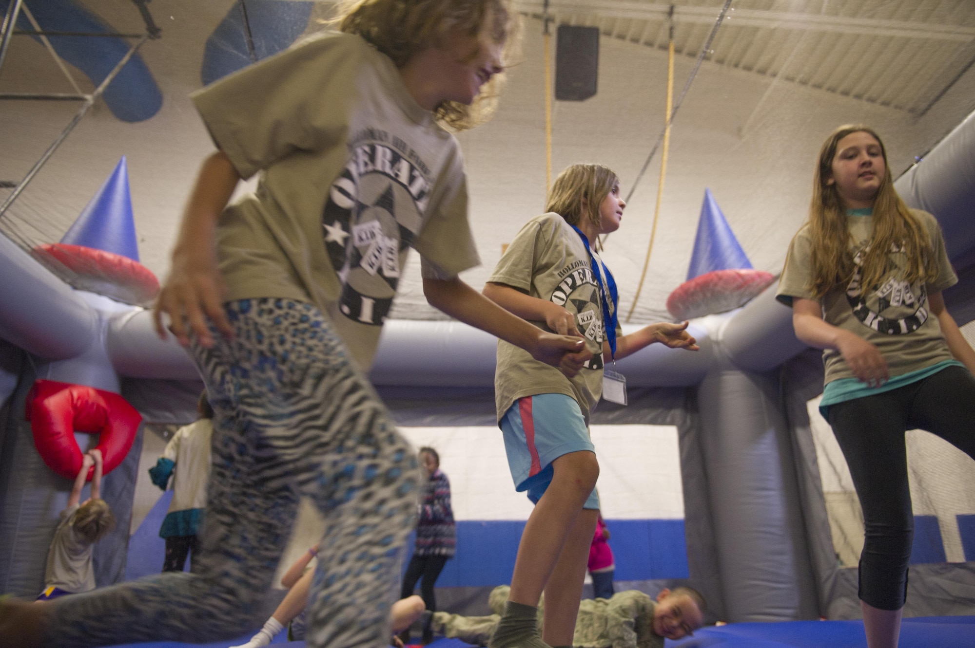 Children enjoy some rest and relaxation in a bouncy castle after returning from Operation K.I.D. (Kids Investigating Deployment), April 8 at Holloman Air Force Base, N.M. The Airmen and Family Readiness Center and the Youth Center provided a show and refreshments to all the participants of Operation K.I.D. April is the Month of the Military Child. The Airmen and Family Readiness Center and Youth Center hosted Operation K.I.D. to expose military children to the different phases of deployment that their active duty family members go through.