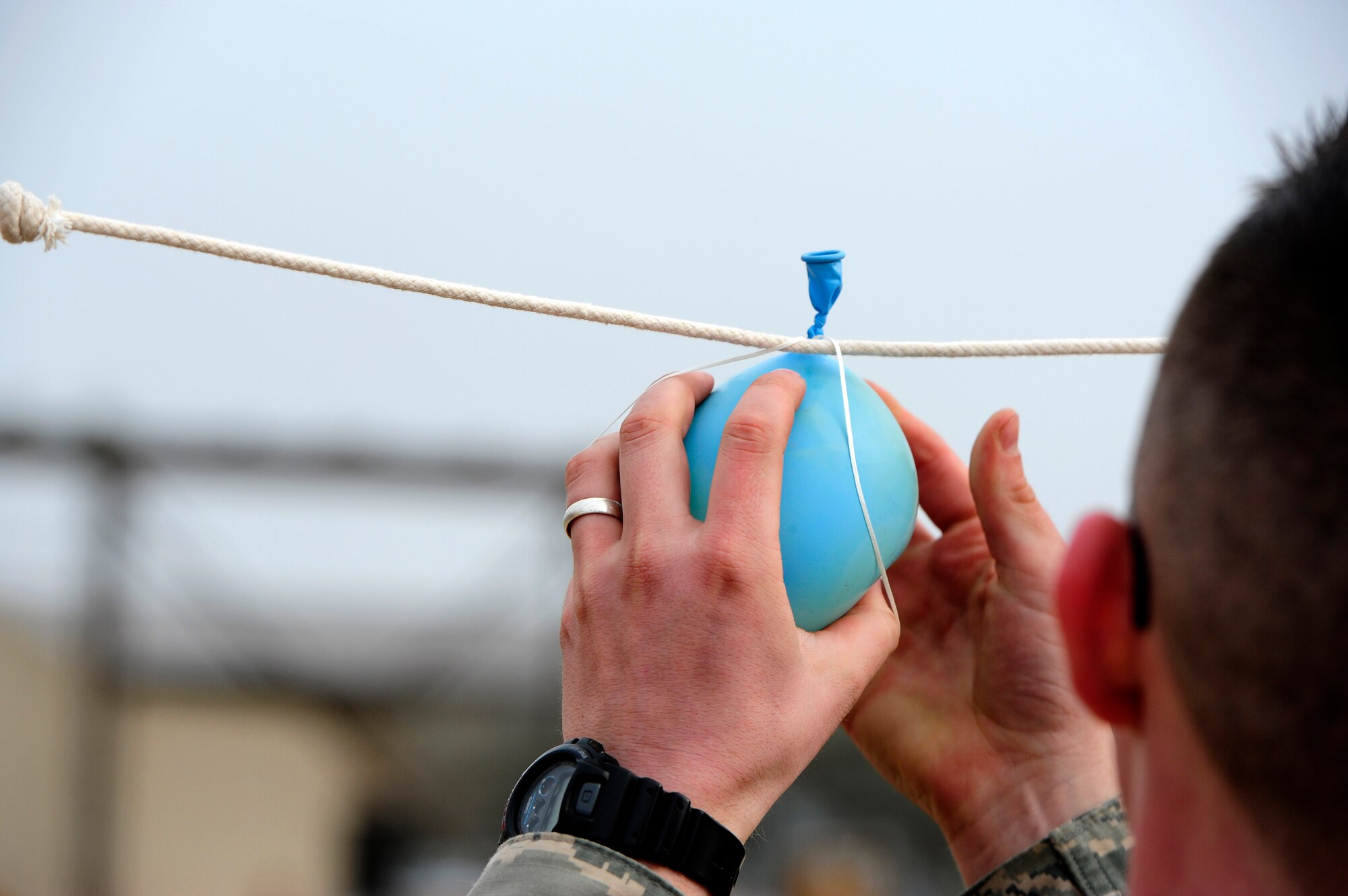 A balloon is tied on a string before the start of a jammer driving contest during a first quarter load crew of the quarter competition at Kunsan Air Base, Republic of Korea, April 8, 2016. During this contest, two jammer drivers from different units battled it out head-to-head, maneuvering their way around cones towards two balloon station. The first driver to pop the balloon and return to his parking spot won the contest. These competitions highlight the high level of proficiency and job knowledge among Airmen in the maintenance community. (U.S. Air Force photo by Staff Sgt. Nick Wilson/Released)

