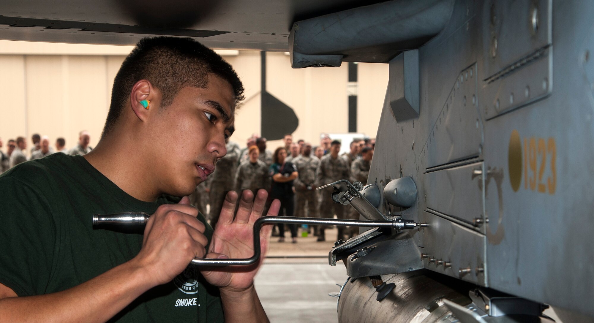 Senior Airman Jonathan White, 80th Aircraft Maintenance Unit load crew member, tightens a bolt to close a panel during a first quarter load crew of the quarter competition at Kunsan Air Base, Republic of Korea, April 8, 2016. One way the Wolf Pack shows the value of superior technical and weapons system expertise is through quarterly weapons load competitions, which help ensure Airmen remain proficient at their jobs. The 8th MXS won the quarterly competition for the third time in a row, which is a first by the same group of Airmen at the Wolf Pack. (U.S. Air Force photo by Staff Sgt. Nick Wilson/Released)