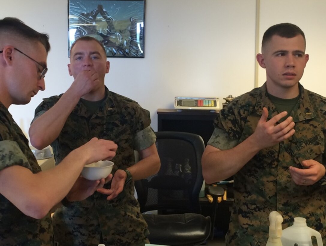 On April 4, 2016 Marines with Combat Engineer Officer's course 5-16 (CEO 5-16) conduct a bite grit test during instruction in Soils and Soils Stabilization at Marine Corps Engineer School aboard Camp Lejeune, N.C. Marines performing this test taste the soil to determine if it is composed of soot or clay which ultimately aids in determining the capabilities of the soil on which a structure is to be built. Pictured from left to right: First Lieutenant Jonathan Lanning Keller and Second Lieutenants Brock Yackey and Troy Searcy.  
