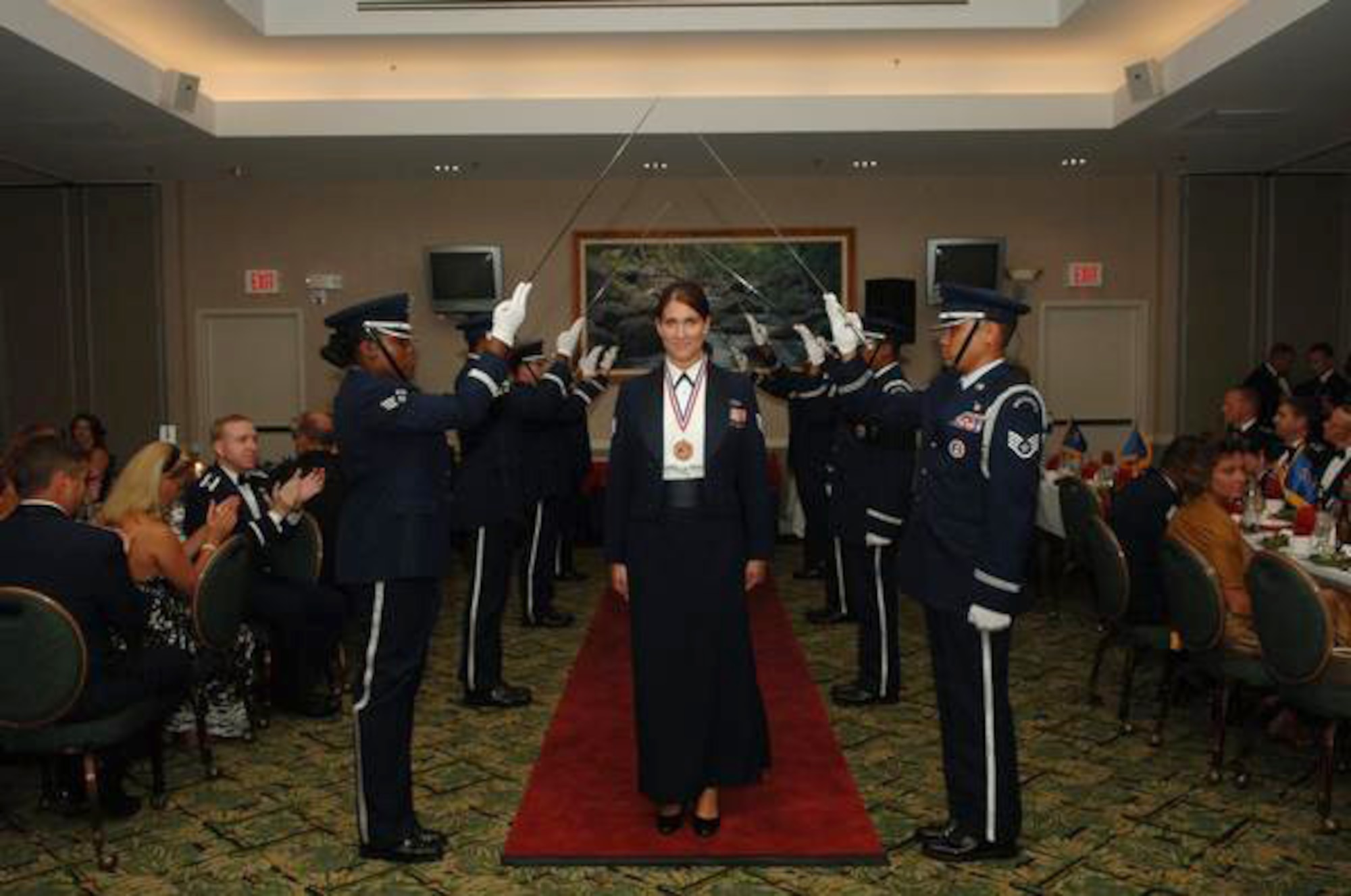 U.S. Air Force Capt., formerly Staff Sgt., Trisha Benish, 17th Operational Weather Squadron weather forecaster, walks in the 2008 annual awards ceremony at Hickam Air Base, HI. Benish began her Air Force career as an enlisted member, commissioned through the medical program and will soon begin a fellowship specializing in emergency medicine. (Courtesy Photo)