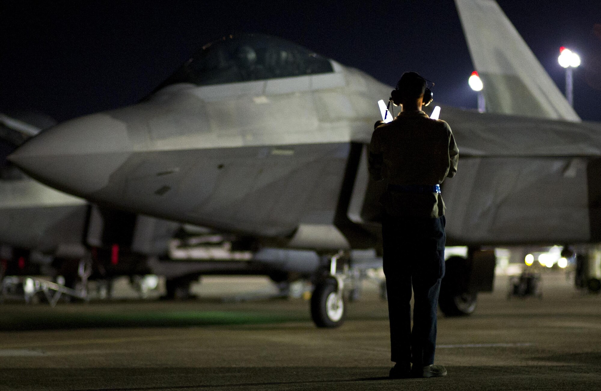 Airman 1st Class Jon Wanser, 95th Aircraft Maintenance Unit crew chief, marshals an F-22 Raptor before takeoff at Tyndall Air Force Base, Fla., April 11, 2016. The world’s only operational 5th generation fighter, the Raptor’s unique combination of stealth, speed, agility, and situational awareness combined with lethal long-range air-to-air and air-to-ground weaponry makes it the best air dominance fighter in the world. (U.S. Air Force photo by Senior Airman Alex Fox Echols III/Released)
