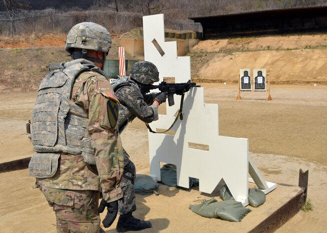 Sgt. Patrick Maurer (left), Headquarters and Headquarters Company, 1st Armored Brigade Combat Team “Ironhorse,” 1st Cavalry Division, observes and offers advice as a South Korean military cadet fires an M4 rifle March 23 during the stress-shoot portion of the “Ironhorse Gauntlet” at Camp Hovey. South Korean military cadets trained with Soldiers from the 1st ABCT before leaving to compete at the Sandhurst Military Skills Competition at the U.S. Military Academy at West Point, New York. (U.S. Army photo by Sgt. Fred Brown, 1st Armored Brigade Combat Team Public Affairs, 1st Cav. Div.)