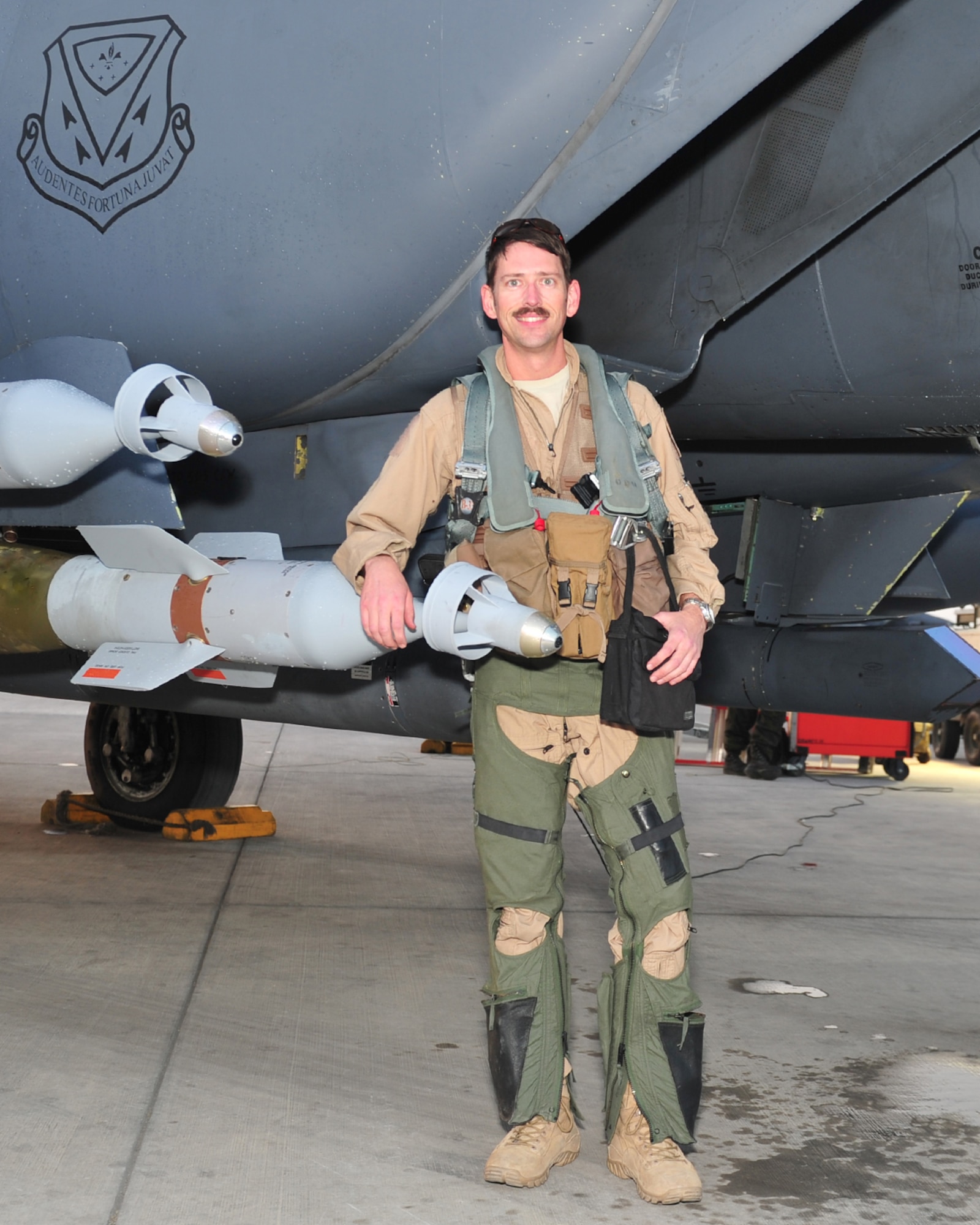 Lt. Col. Bash, 391st Expeditionary Fighter Squadron weapons system officer and instructor, poses for a photo with an F-15E Strike Eagle fighter aircraft after returning from his 1,000 combat flying hour milestone sortie at undisclosed location in Southwest Asia, April 9, 2016. The 1,000 hour milestone, an equivalent to more than 40 days in combat, is lauded as a rare achievement, which some flyers never achieve. (U. S. Air Force photo by Staff Sgt. Kentavist P. Brackin/Released)