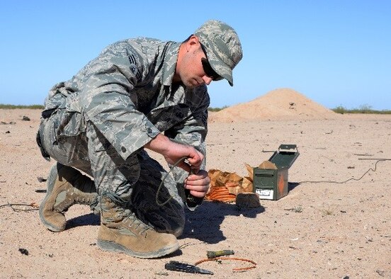 Senior Airman Daniel McCarthy, 944th Civil Engineer Squadron Explosive Ordnance Disposal flight technician, attaches a length of time fuse to a pyrotechnic fuse igniter March 12, 2016 in Gila Bend, Ariz. During proficiency training, EOD technicians go over techniques and procedures as well as general safety. (U.S. Air Force photo by Staff Sgt. Nestor Cruz)