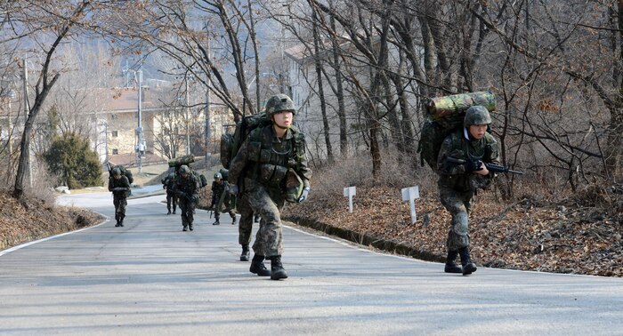 South Korean military cadets from the Korea Military Academy, Seoul, South Korea, foot march two or three miles between each event of the Ironhorse Gauntlet March 23 at Camp Hovey. The timed series of challenges pushed cadets to their physical limit as they prepared for the Sandhurst Military Skills Competition at the U.S. Military Academy at West Point, New York. (U.S. Army photo by Sgt. Fred Brown, 1st Armored Brigade Combat Team Public Affairs, 1st Cav. Div.)