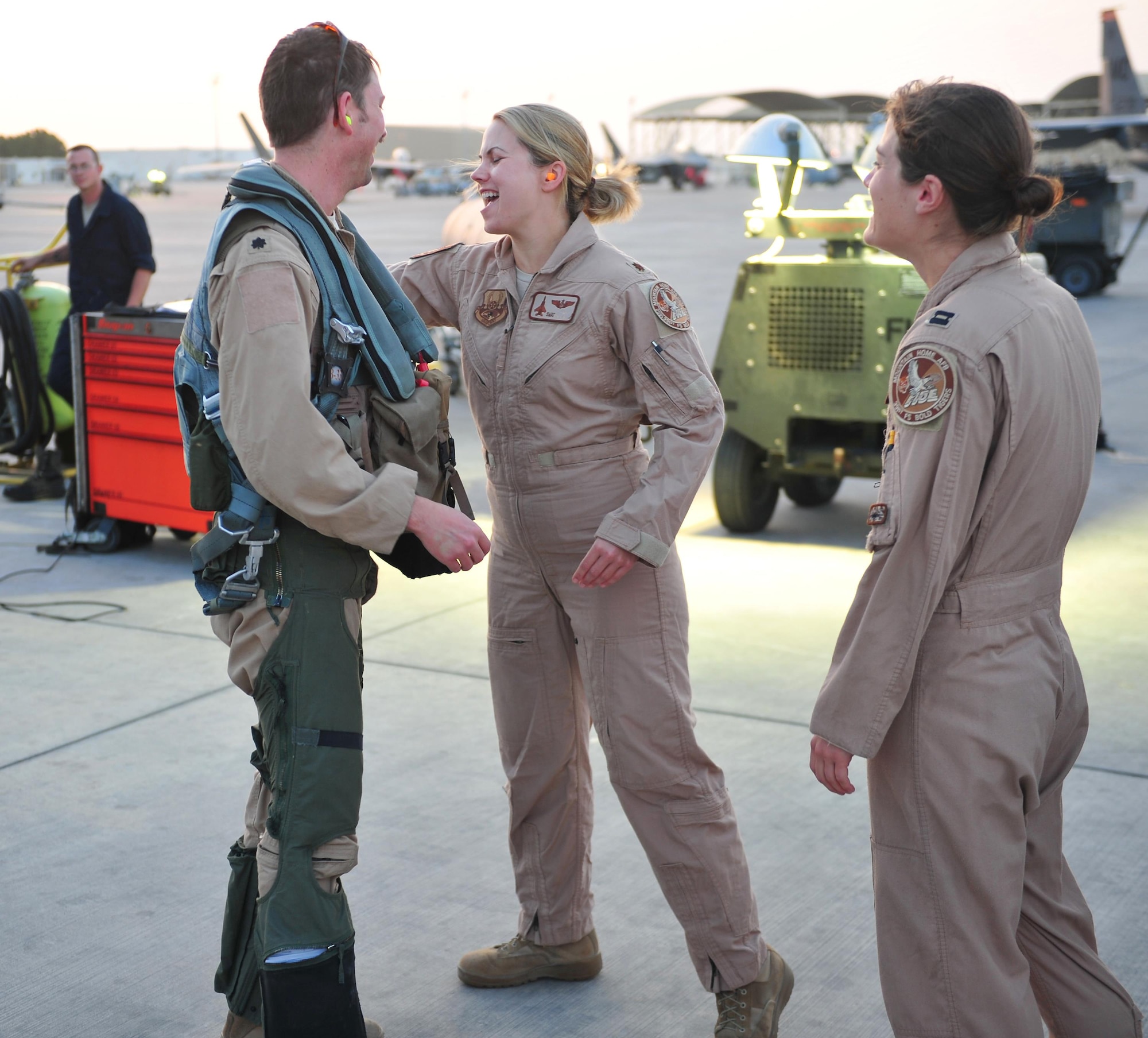 Lt. Col. Bash, 391st Expeditionary Fighter Squadron weapons system officer and instructor, is congratulated by Maj. Swat, 391st EFS WSO, on passing 1,000 combat flying hour milestone at an undisclosed location in Southwest Asia, April 9, 2016. Bash achieved the milestone during the 177th combat mission of his career while supporting Operation Inherent Resolve. (U. S. Air Force photo by Staff Sgt. Kentavist P. Brackin/Released)