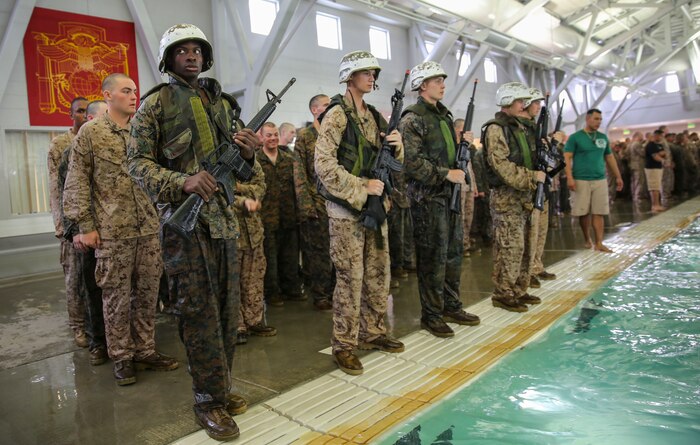 Recruits of Lima Company, 3rd Recruit Training Battalion, perform the 10-second gear strip while submerged during the Water Survival Basic Qualification at Marine Corps Recruit Depot San Diego, April 11. This event helped train recruits to quickly strip heavy gear that may inhibit their ability to float while in deep water. Annually, more than 17,000 males recruited from the Western Recruiting Region are trained at MCRD San Diego. Lima Company is scheduled to graduate June 10.