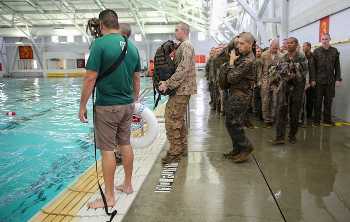 Recruits of Lima Company, 3rd Recruit Training Battalion, prepare to perform a 25-meter swim using a waterproof pack during the Water Survival Basic Qualification at Marine Corps Recruit Depot San Diego, April 11. The swim qualification introduces new challenges that recruits must overcome in order to graduate recruit training. Annually, more than 17,000 males recruited from the Western Recruiting Region are trained at MCRD San Diego. Lima Company is scheduled to graduate June 10.