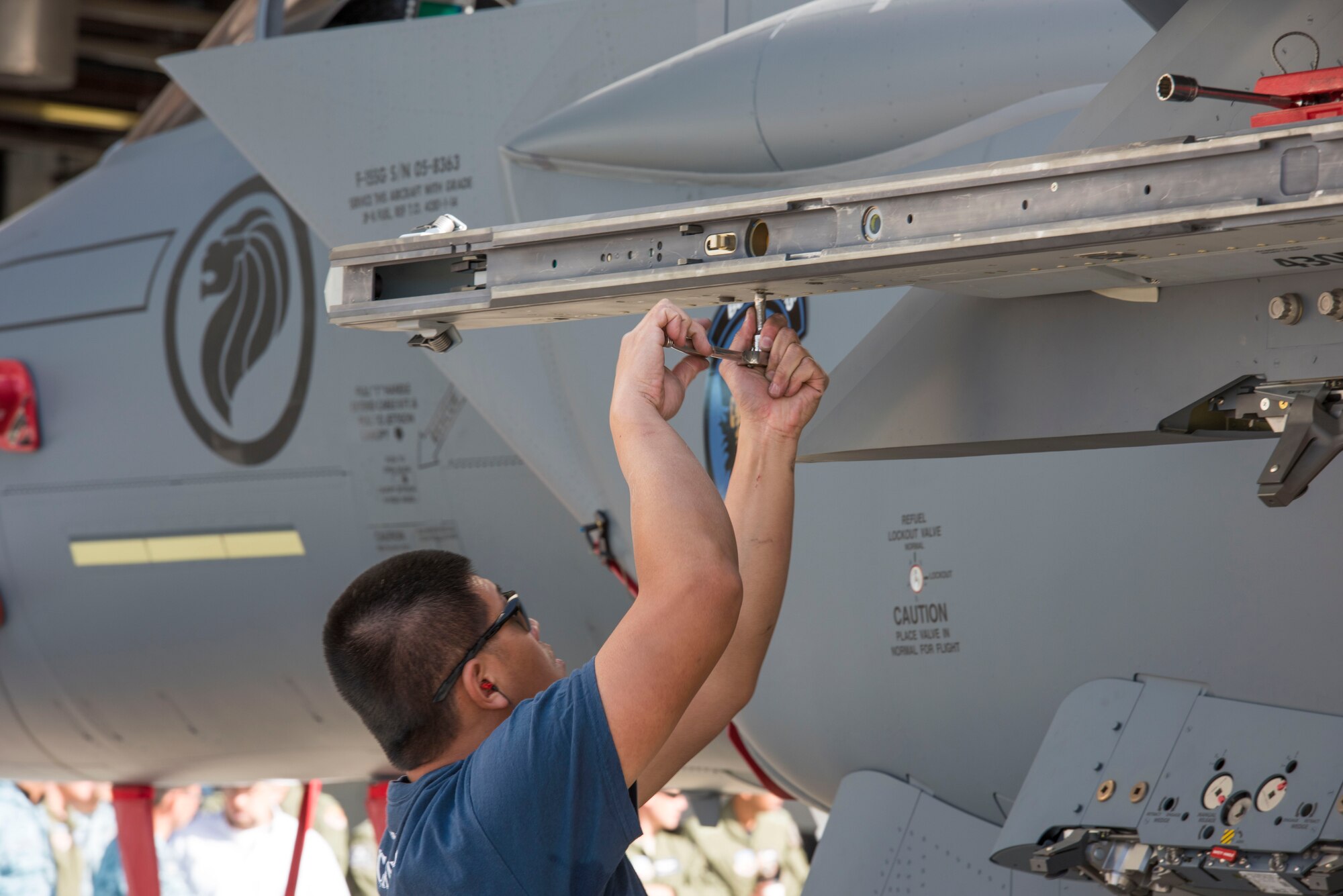 ME2-1 Vincent Law, 428th Aircraft Maintenance Unit flightline crew member, makes final adjustments April 9, 2016, at Mountain Home Air Force Base, Idaho. The maintenance load competition simulates the pressure of a deployed environment when load crews need to work quickly and efficiently to prepare jets for missions. (U.S. Air Force photo by Airman Alaysia Berry/RELEASED)