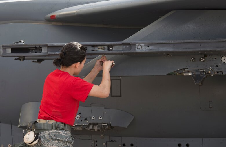 Airman 1st Class Samantha Archide-Proctor, 389th Aircraft Maintenance Unit weapons load crew member, participates in a load competition, April 9, 2016, at Mountain Home Air Force Base, Idaho. The competition simulates deployed settings while loading munitions onto aircraft. (U.S. Air Force photo by Airman 1st Class Chester Mientkiewicz/Released)