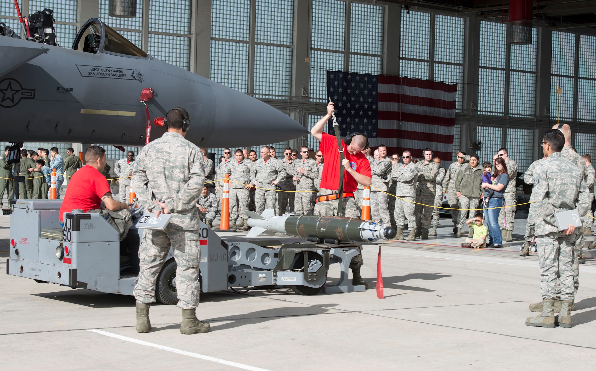 Staff Sgt. Grant Wrinkle, 389th Aircraft Maintenance Unit weapons load crew chief, prepares to fasten down a munition during a load crew competition, April 9, 2016, at Mountain Home Air Force Base, Idaho. The competition pitted two load crews against each other to prepare for combat situations. (U.S. Air Force photo by Airman 1st Class Chester Mientkiewicz/Released)