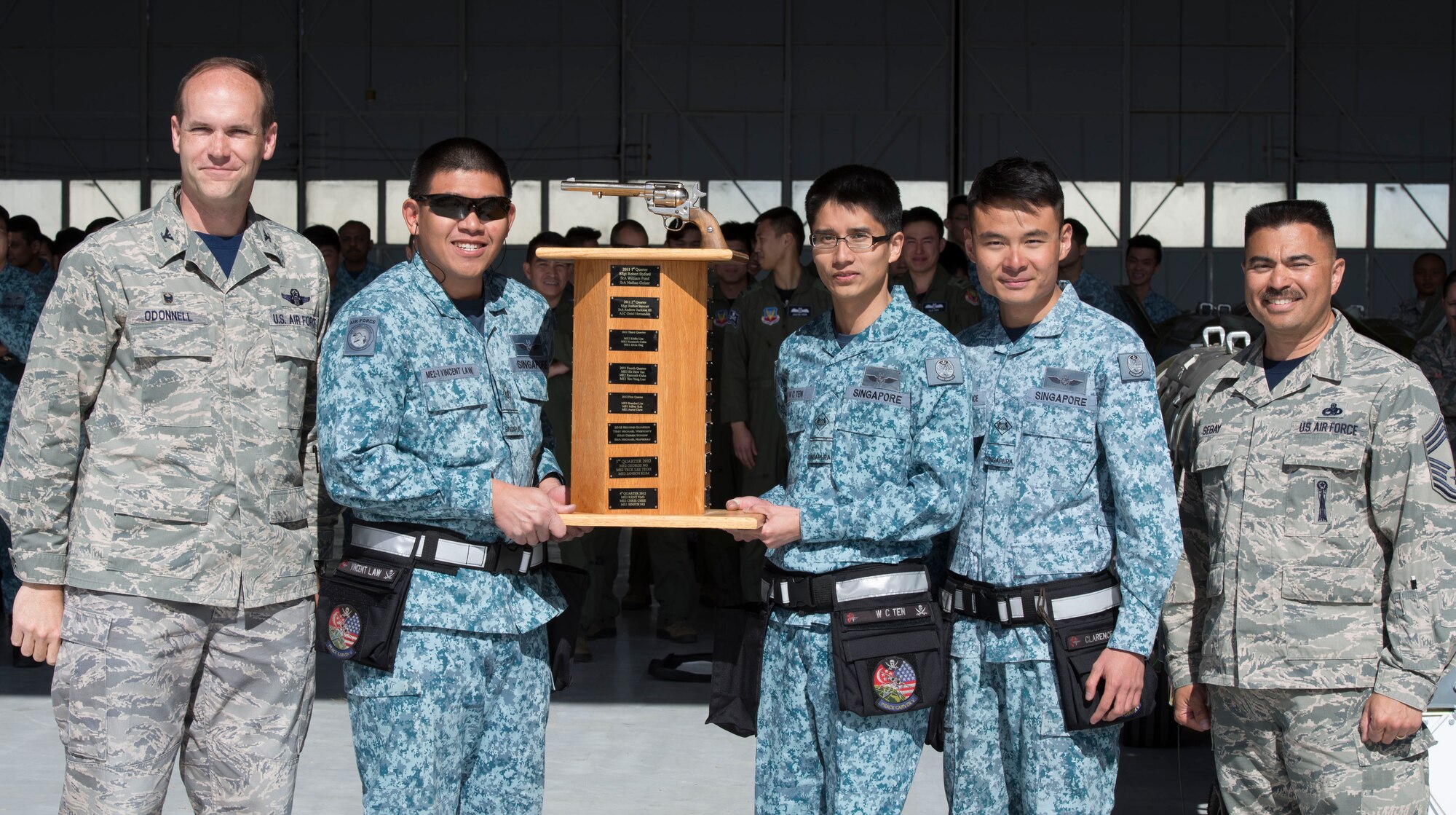366th Fighter Wing Commander Col. Jefferson O'Donnell and Wing Weapons Manager Chief Master Sgt. Patrick Sebay recognize the Republic of Singapore load crew team for winning the load competition April 9, 2016, at Mountain Home Air Force Base, Idaho. The 428th Aircraft Maintenance Unit beat the 389th AMU weapons load crew team by 6 minutes and 50 seconds in the quarterly competition. (U.S. Air Force photo by Chester Mientkiewicz/Released)
