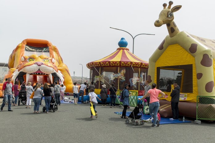 Station residents attend the 13th annual Month of the Military Child festival at Marine Corps Air Station Iwakuni, Japan, April 9, 2016. The month of April honors and recognizes military children for the struggles they overcome such as frequent moves, school changes and separation from active duty parents. The festival also offered children the opportunity to play games, get their faces painted, draw, dance and participate in a raffle. A blow-up bouncy house, carousel, slide, and basketball hoop provided children with additional activities. (U.S. Marine Corps photo by Lance Cpl. Aaron Henson/Released)