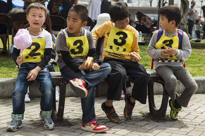 Japanese children from the Atago Kodomo-Kai, Mount Atago, eat food and socialize during the 13th annual Month of the Military Child festival at Marine Corps Air Station Iwakuni, Japan, April 9, 2016. The month of April honors and recognizes military children for the struggles they overcome such as frequent moves, school changes and separation from active duty parents. Approximately 500 American and Japanese children and their families attended the festival to enjoy free food, play games, face paint, draw, dance, participate in raffles and have story time. (U.S. Marine Corps photo by Lance Cpl. Aaron Henson/Released)