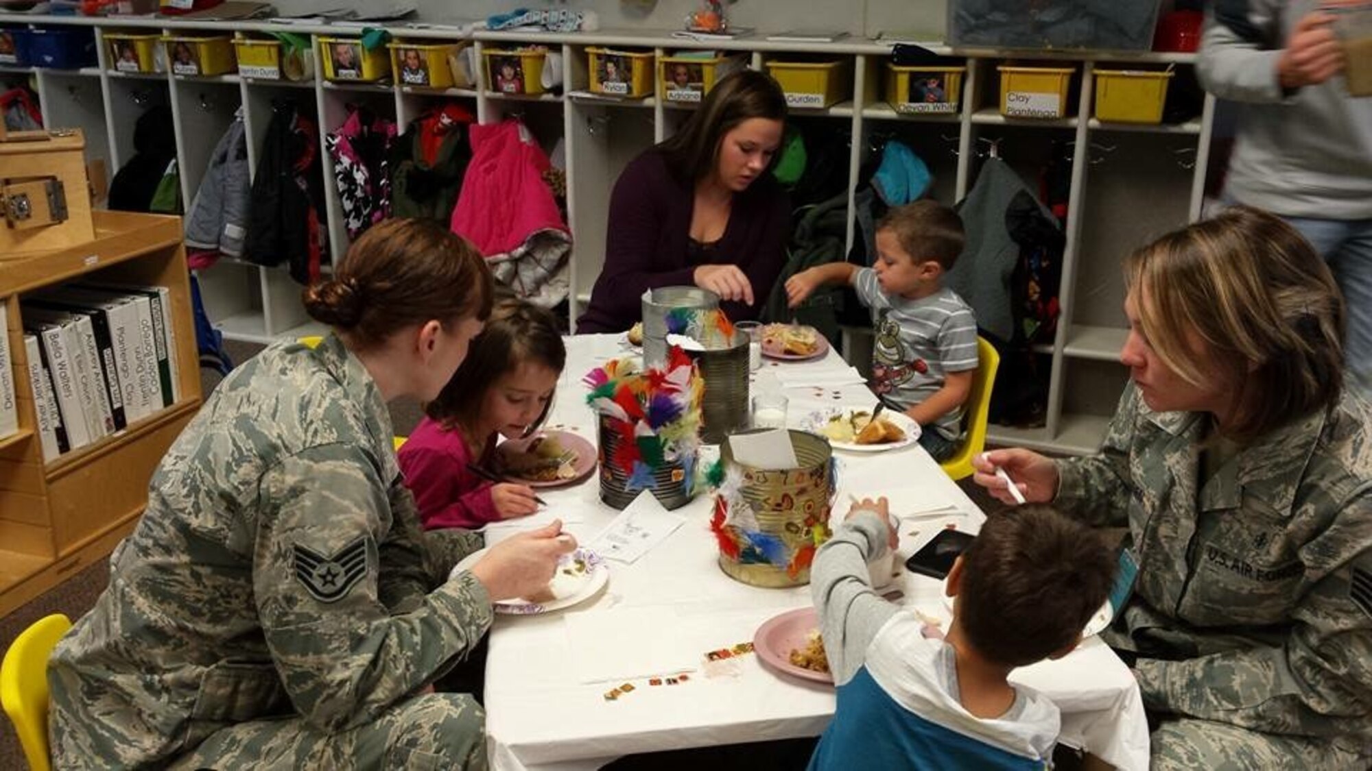 Staff Sgt. Shannon Olson, left, 28th Bomb Wing chaplain assistant, spends time with children in the Youth Center at Ellsworth Air Force Base, S.D., Nov. 19, 2015. Parents were invited to the center for a special event to celebrate Thanksgiving with their children. (Courtesy photo by Staff Sgt. Shannon Olson/Released)