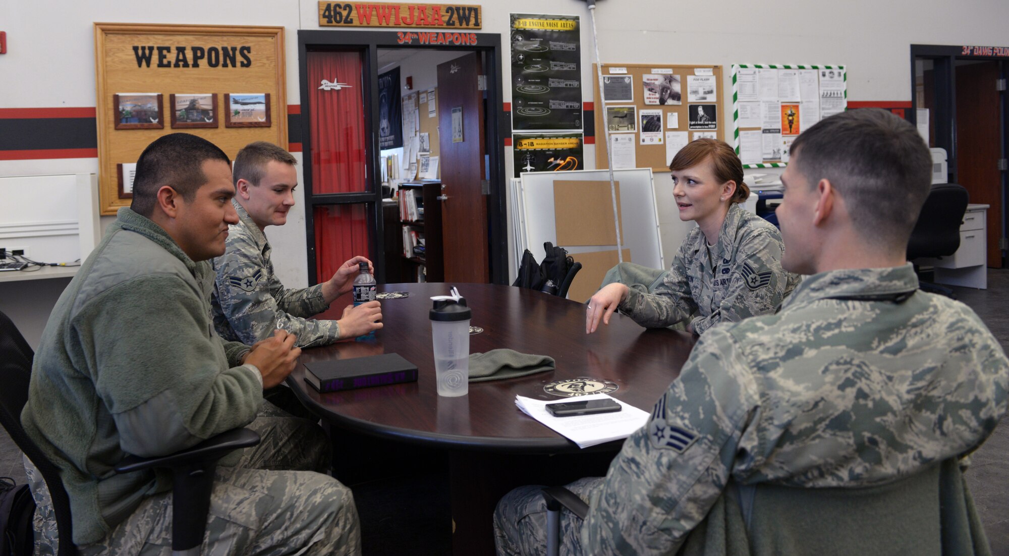 Staff Sgt. Shannon Olson, 28th Bomb Wing chaplain assistant, chats with Airmen from the 28th Aircraft Maintenance Squadron at Ellsworth Air Force Base, S.D., March 30, 2016. Because some Airmen are skeptical to talk with the chaplain due to rank, the chaplain’s assistant acts as a liaison between the two to bridge the gap. (U.S. Air Force photo by Airman Donald C. Knechtel/Released)