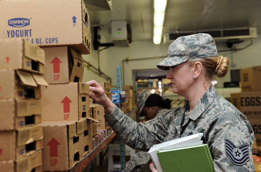 Tech. Sgt. Shannon Thomas, 28th Medical Operations Squadron Public Health flight chief, checks the expiration date on yogurt cartons at the Commissary at Ellsworth Air Force Base, S.D., April 6, 2016. Certain expired foods, such as canned goods and juice, are donated to the food bank once taken off the shelf and inspected by the Public Health office for broken seals or dented cans at the seal. (U.S. Air Force photo by Senior Airman Hailey R. Staker/Released)