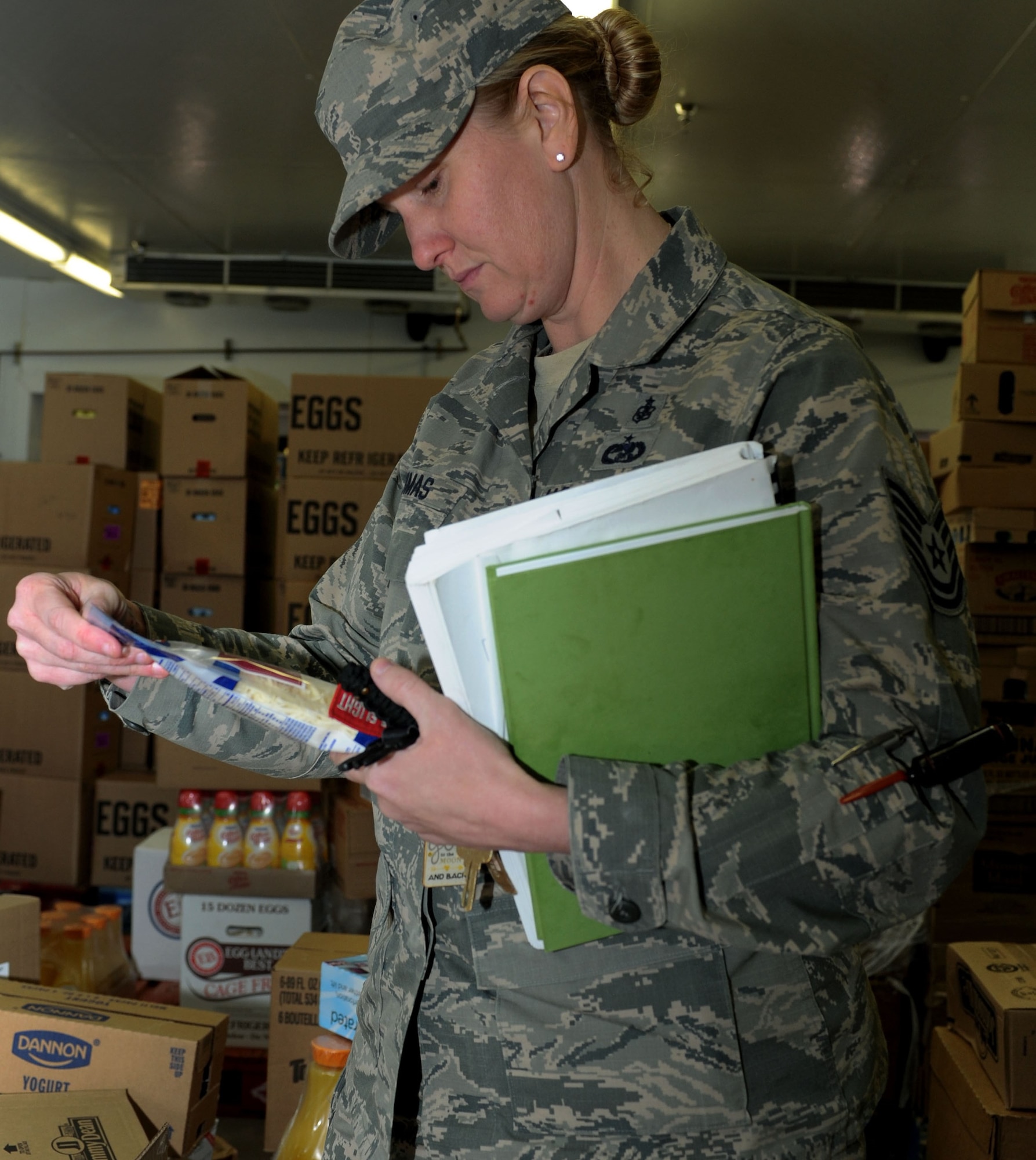 Tech. Sgt. Shannon Thomas, 28th Medical Operations Squadron Public Health flight chief, checks the expiration date of shredded cheese at the Commissary at Ellsworth Air Force Base, S.D., April 6, 2016. Ellsworth AFB eating establishments, such as the dining facility and the Dakota’s Club, as well as the Commissary and food trucks parked outside the BX, must be inspected monthly to ensure standards are being met and expired products are not left on the shelves. (U.S. Air Force photo by Senior Airman Hailey R. Staker/Released)