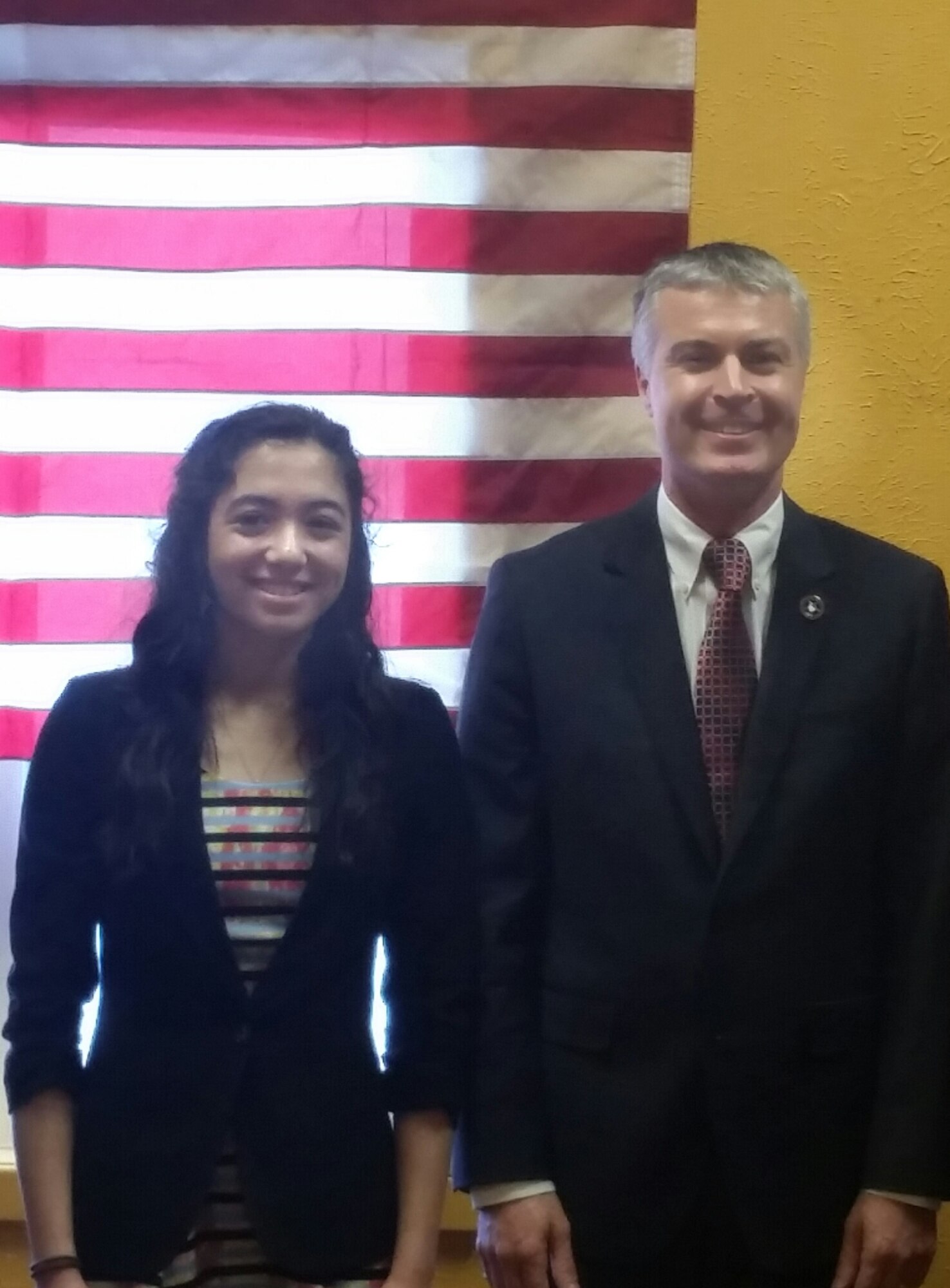 Ria Gualano, daughter of Lan Gualano, 28th Comptroller Squadron quality assurance manager, is commemorated by Marty Jackley, South Dakota Attorney General, for being selected as South Dakota’s Military Youth of the Year, at Box Elder, S.D., March 21, 2016. For the competition, applicants had to write four essays covering different areas in teen life and their vision for the youth in America. (Courtesy photo by Lan Gualano/Released)