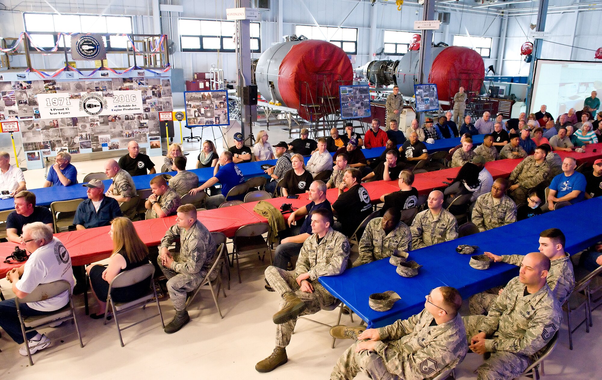 Propulsion Flight legacy celebration attendees listen to Kevin Morrow, 436th Maintenance Squadron jet engine shop supervisor and master of ceremony for the event March 25, 2016, on Dover Air Force Base, Del. Over 200 current and former Propulsion Flight members as well as their family members attended the ceremony that highlighted General Electric TF39 engine production and testing at Dover AFB and marking the end of an era after 45 years. The last TF39 produced and accepted as serviceable on March 30. (U.S. Air Force photo/Roland Balik)