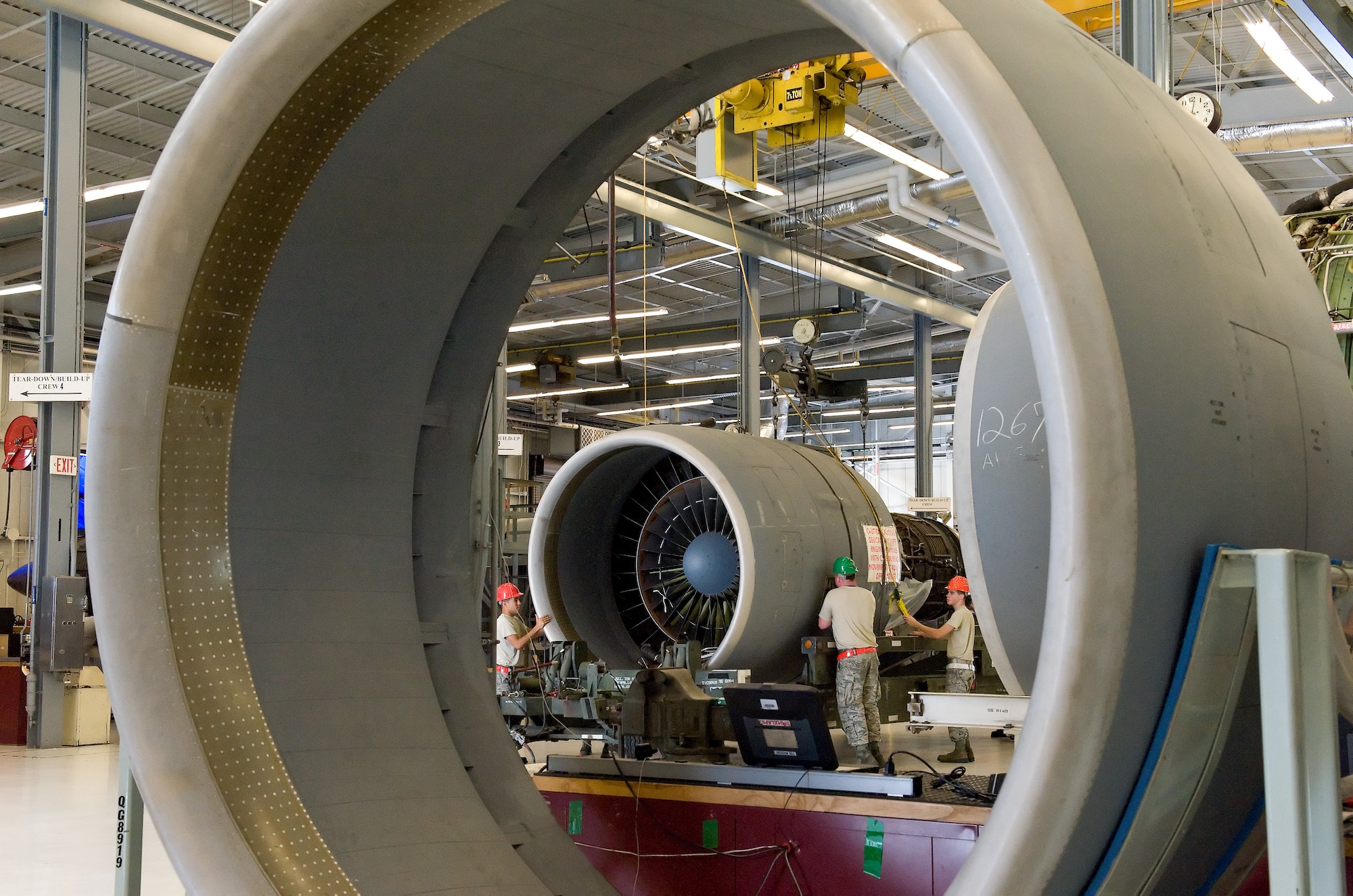 Looking through the nacelle of a General Electric TF39 engine, Airmen assigned to the 436th Maintenance Squadron Jet Engine Intermediate Maintenance flight secure a TF39 engine to an engine trailer July 21, 2014, on Dover Air Force Base, Del. The weight of an operational engine is more than 7,200 pounds and is capable of 41,000 pounds of takeoff thrust for legacy C-5A/B Galaxy aircraft. (U.S. Air Force photo/Roland Balik)