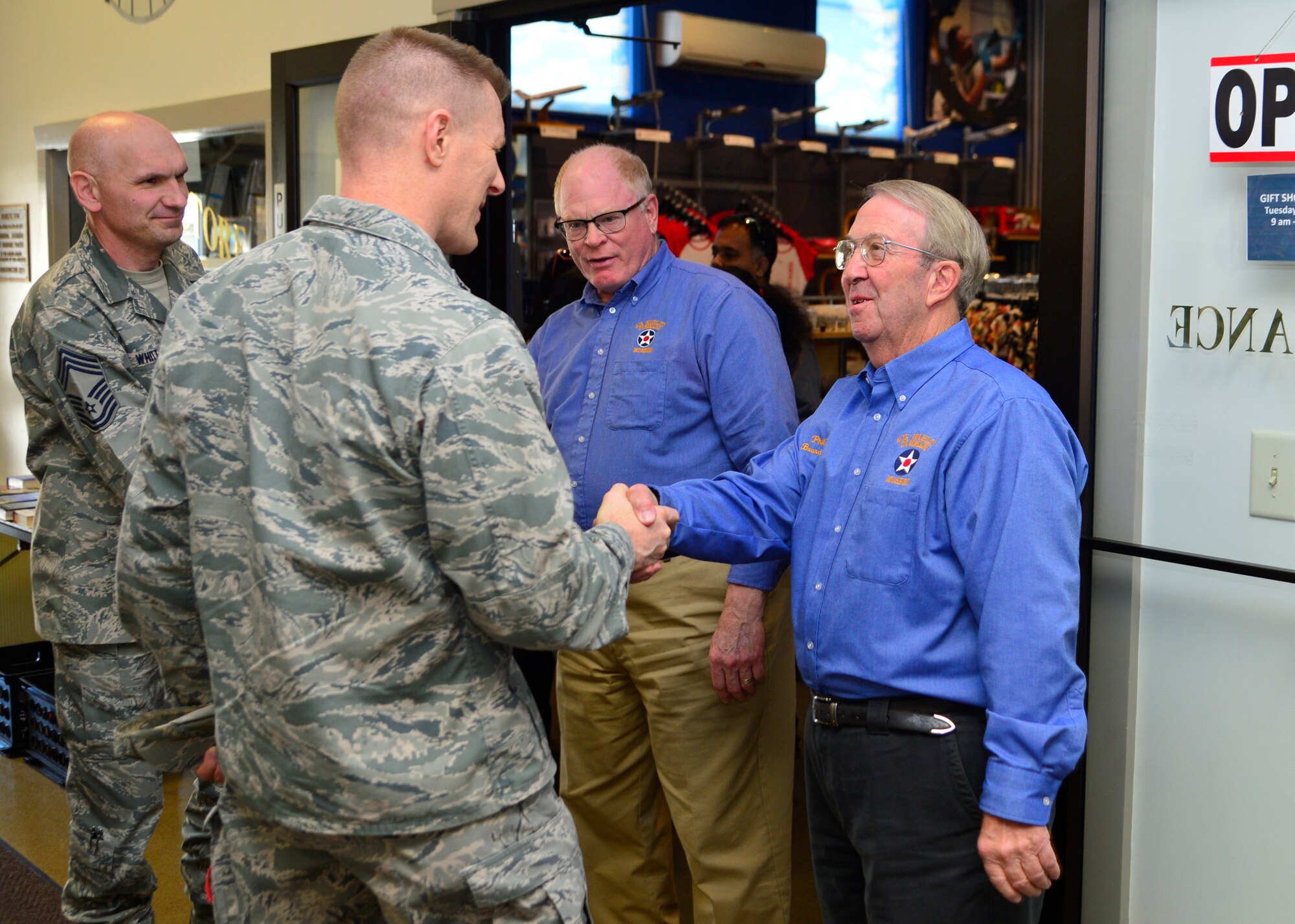 Col. Michael Grismer, 436th Airlift Wing commander, shakes hands with Phil White, Air Mobility Command Museum Foundation Board secretary, during a visit to the AMC Museum March 30, 2016, at Dover Air Force Base, Del. Grismer visited the museum to see upcoming projects and summer programs offered to the community. (U.S. Air Force photo/Senior Airman William Johnson)