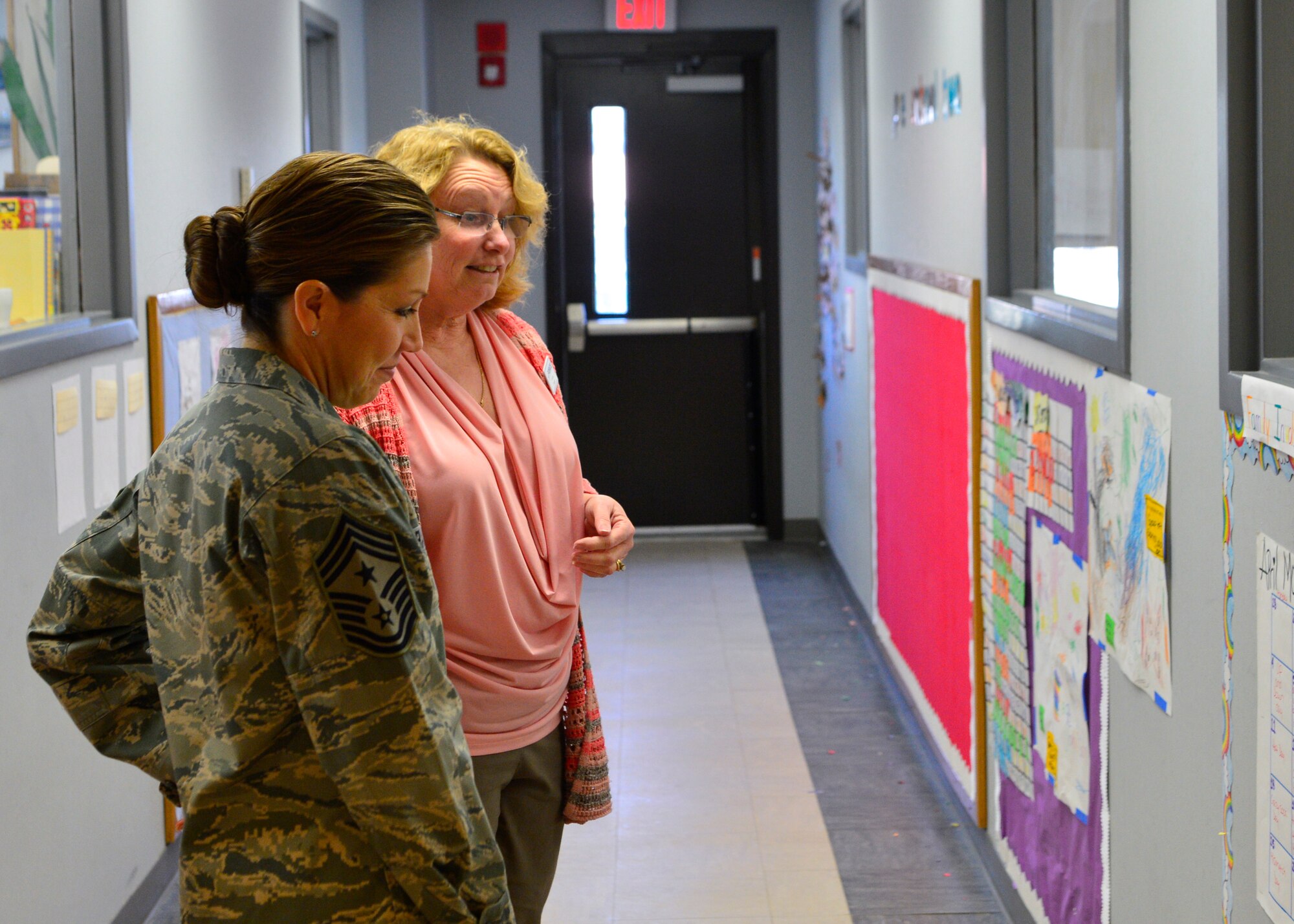 Chief Master Sgt. Sarah Sparks, 436th Airlift Wing command chief, looks at drawings from children April 6, 2016, while touring the Child Development Center on Dover Air Force Base, Del. Sparks was given an in-depth tour of the facility and how the CDC operates. (U.S. Air Force photo/Senior Airman William Johnson)