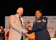 Staff Sgt. Jasmine Phillips, 92nd Aerospace Medicine Squadron NCO in charge of infection control, receives the Noncommissioned Officer of the Year Award from the West Plains Chamber of Commerce at the Best of the West Awards Gala April 8 in Airway Heights, Wash. The event recognized outstanding contributions to the local community. (U.S. Air Force photo/Senior Airman Sam Fogleman)
