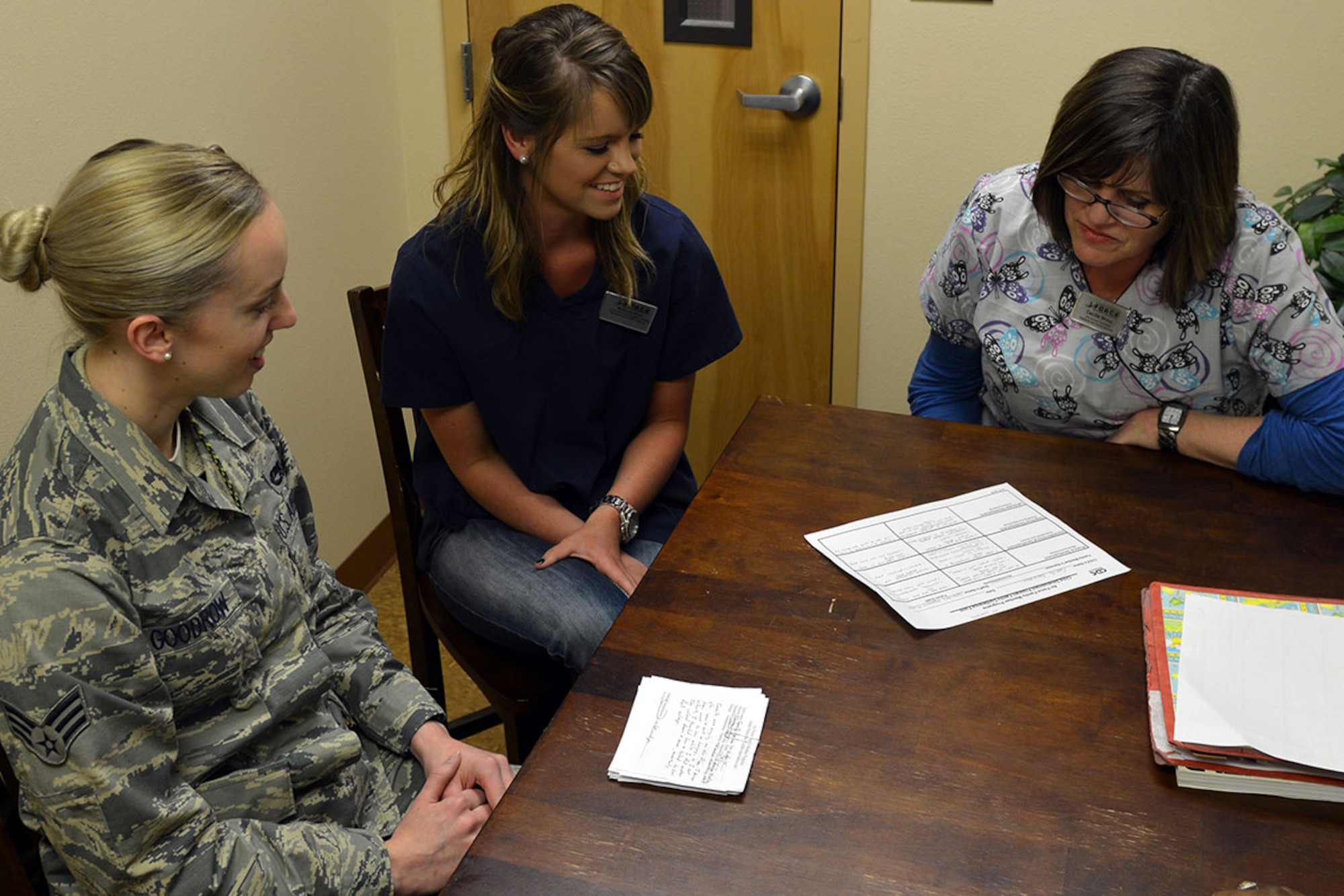 Senior Airman Jenise Goodrow, 3rd Maintenance Squadron low observable journeyman, discusses her daughters progress with Mackenzie Rivera, Denali Child Development Center child and youth program assistant, and Cecilia Hone, Denali CDC youth program technician at the Denali CDC, on Joint Base Elmendorf-Richardson, Alaska, April 6, 2016. More than a thousand families are expected to participate in the parent conferences throughout all JBER CDCs.(U.S. Air Force photo by Airman 1st Class Javier Alvarez)