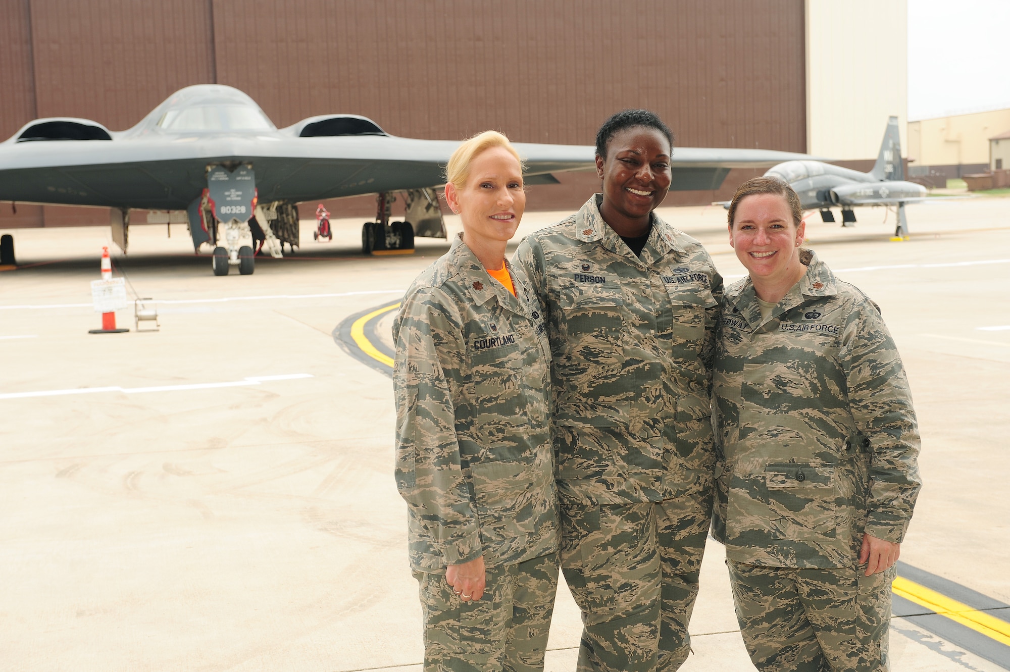 Maj. Kellie Courtland, left, 509th Logistics Readiness Squadron commander, Maj. Redahlia Person, center, 509th Maintenance Squadron commander, and Maj. Catherine Tredway, 509th Force Support Squadron commander, stand in front of 509th Bomb Wing B-2 Spirit and T-38 Talon aircraft July 24, 2015 at Whiteman Air Force Base, Mo. March is Women’s History Month (WHM), and the trio represent the 2016 WHM theme, “Working to Form a More Perfect Union: Honoring Women in Public Service and Government
(U.S. Air Force photo by Airman 1st Class Jazmin Smith)

