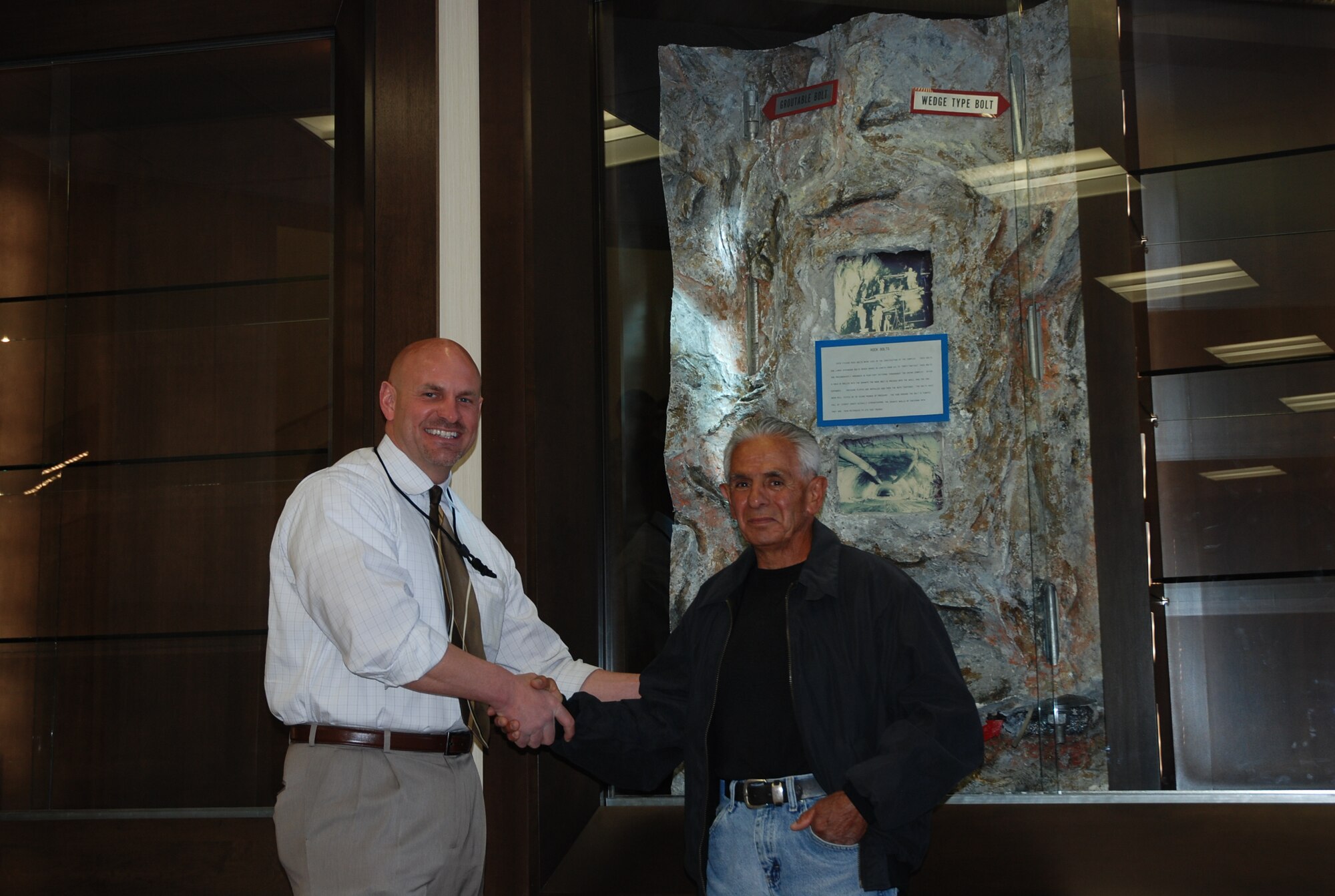 CHEYENNE MOUNTAIN AIR FORCE STATION, Colo. – Dino Bonaldo, 721st Civil Engineer Squadron director, left, greets Ted Martinez on a recent return visit to Cheyenne Mountain Air Force Station. Martinez worked many years at CMAFS, including a couple of years packing dynamite and blasting the mountain to make way for the facility that would go fully operational in April 1966. (U.S. Air Force photo by Dave Smith)