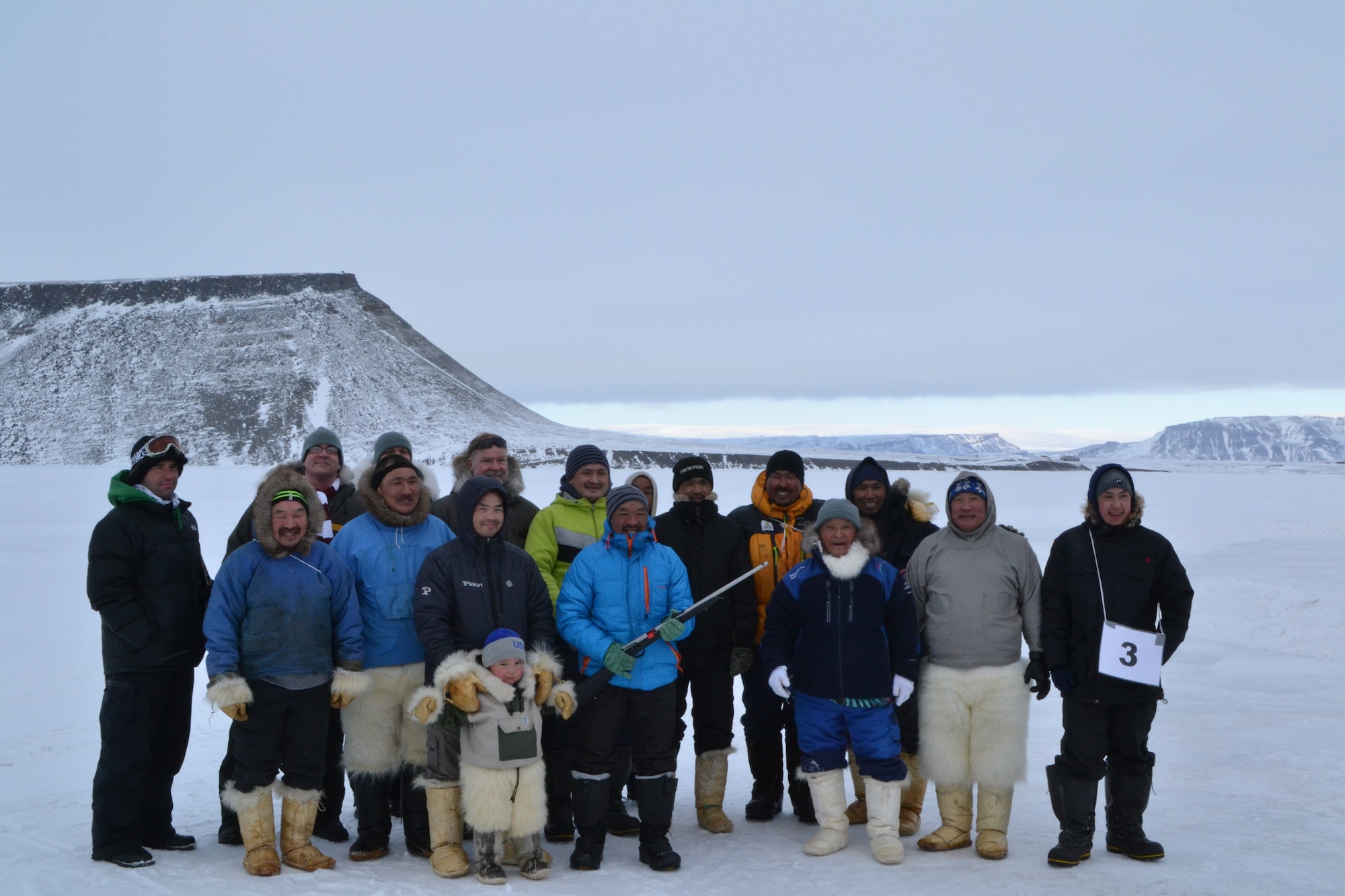 THULE AIR BASE, Greenland – From left rear, Master Sgt. Jason Linta, race coordinator, Col. Stuart Pettis, 821st Air Base Group commander, Master Sgt. Joseph Rivera, race coordinator, and Lt. Col. Kim Mikkelsen, Danish liaison officer gather with the hunters who raced in the Armed Forces Day 10 km dog sledge race. (U.S. Air Force Photo by Capt Douglas Ruark)