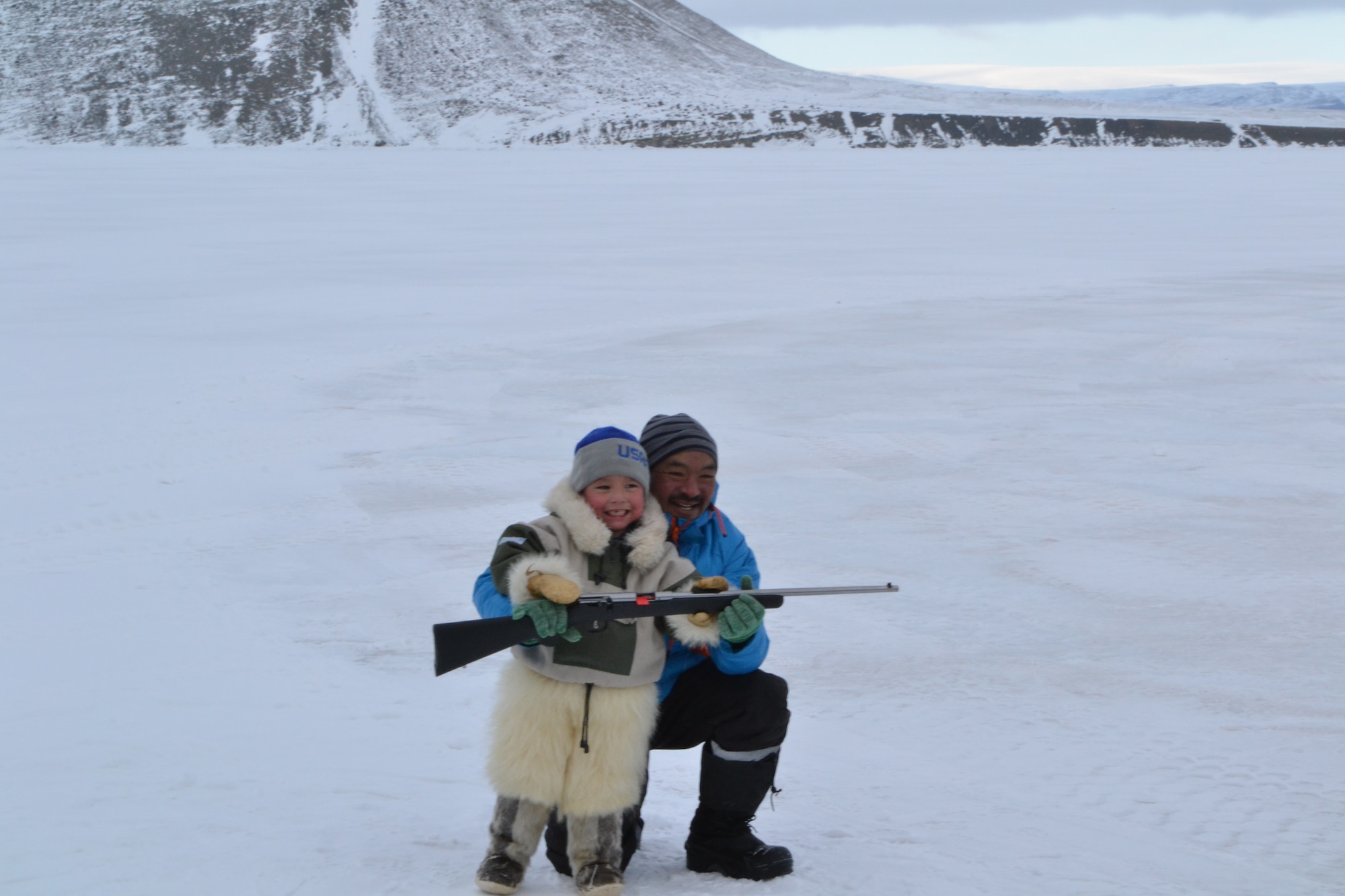 THULE AIR BASE, Greenland – The winner of the Armed Forces Day 10 km dog sledge race shows off his prize with the youngest traveler to attend the event. The boy endured 4 days of travel on the cold ice to join Thule personnel for Armed Forces Day. (U.S. Air Force Photo by Capt. Douglas Ruark)