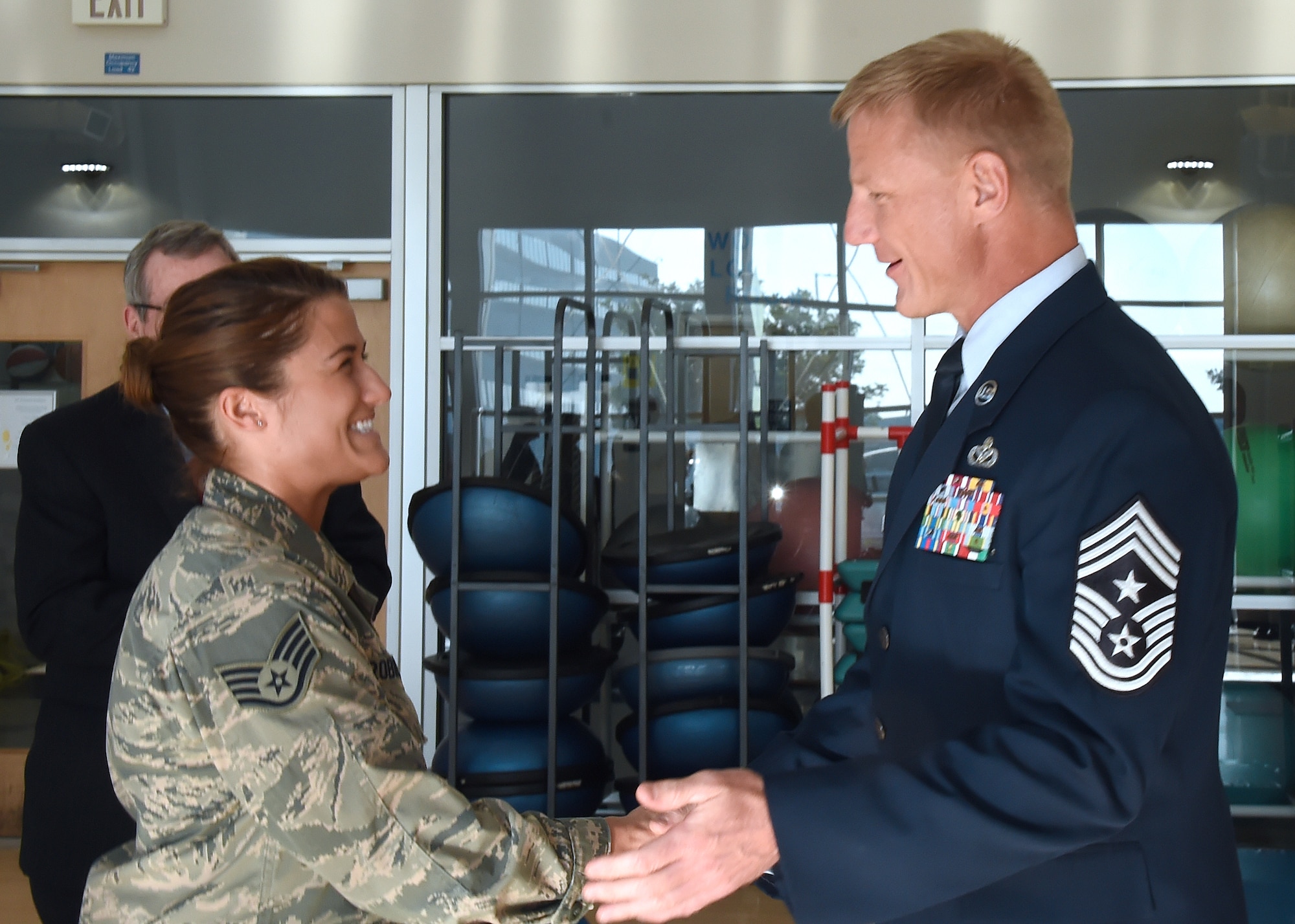 Chief Master Sgt. Craig Hall, Space and Missile Systems Center command chief, congratulates Staff Sgt. Katelin Robinson on her selection for Officer Training School through the Senior Leader Enlisted Commissioning Program. Robinson is the 61st Medical Squadron's noncommissioned officer in charge of Dental Logistics at the Los Angeles Air Force Base medical clinic in El Segundo, Calif. (U.S. Air Force photo/Sarah Corrice)