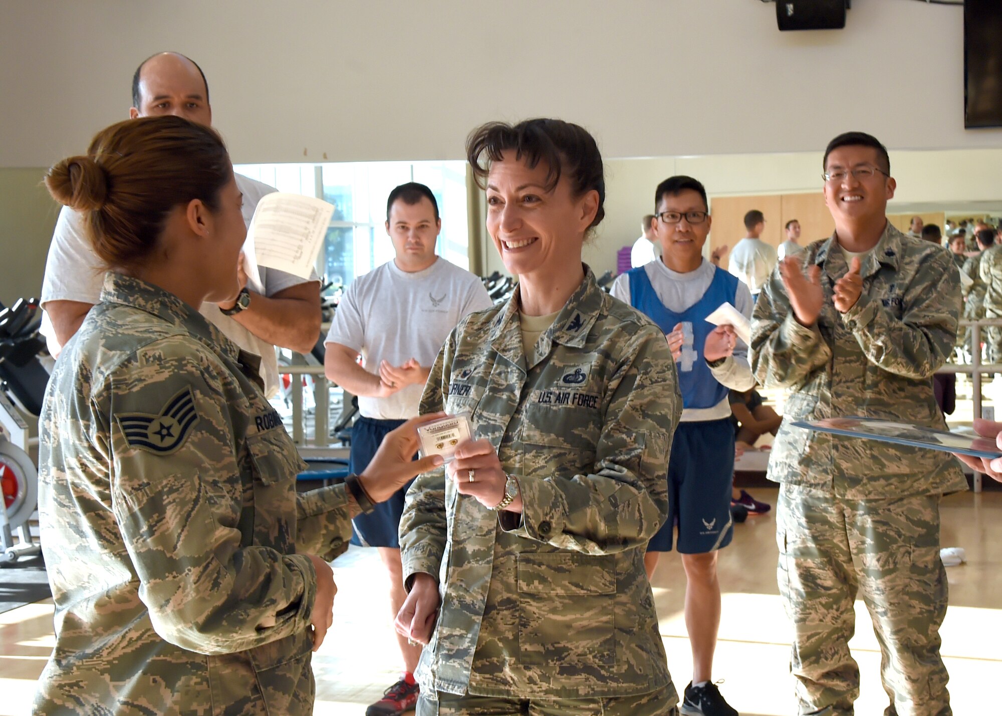 Col. Donna Turner, 61st Air Base Group commander, presents a pair of gold bars, signifying the rank of a 2nd Lieutenant, to Staff Sgt. Katelin Robinson upon her selection for Officer Training School through the Senior Leader Enlisted Commissioning Program. Robinson is the 61st Medical Squadron's noncommissioned officer in charge of Dental Logistics at the Los Angeles Air Force Base medical clinic in El Segundo, Calif. (U.S. Air Force photo/Sarah Corrice)