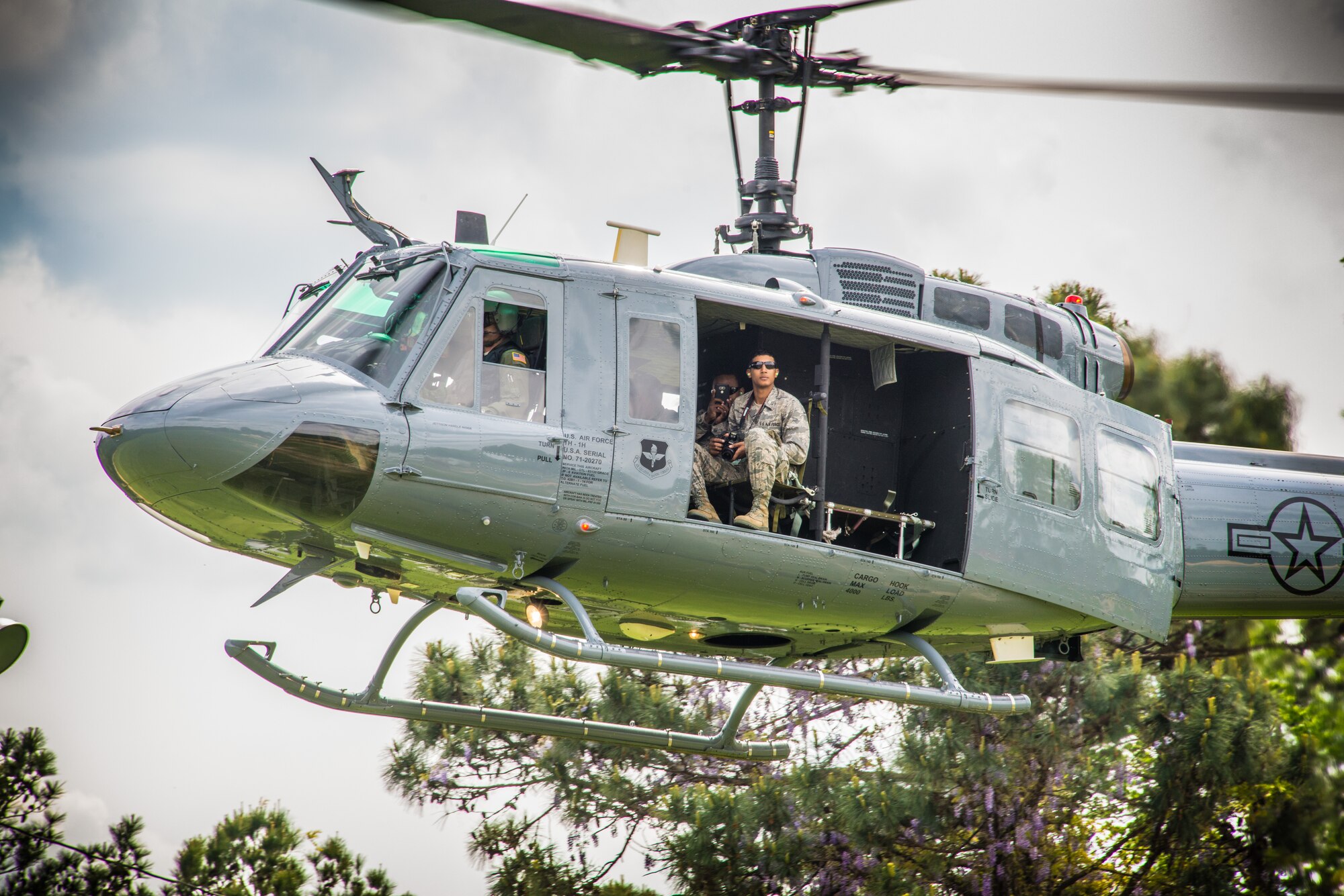 Cadet Elaine Arnwine, an AFROTC student at Tuskegee University enjoys the view from a UH-TH1 Huey as the aircraft hovers over the university's football field. Two helicopters from the 23rd Flying Training Squadron at Fort Rucker, Alabama, flew to Tuskegee University in Tuskegee, Alabama, April 6, to give orientation flights on TH-UH1 Hueys(Photo by Stanley Ward III)
