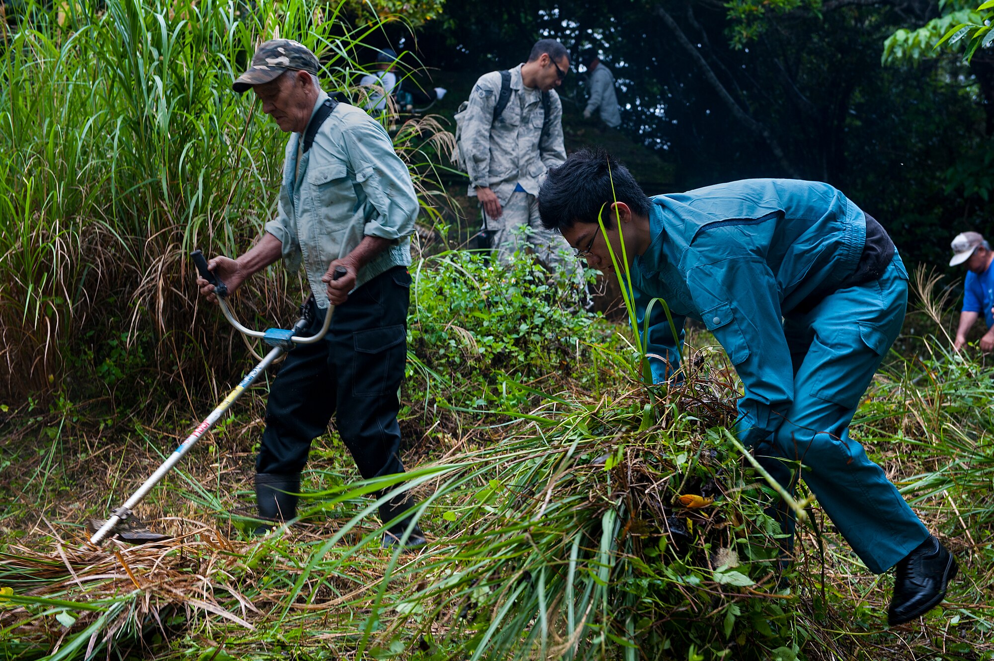 An Okinawan family cleans the tomb of their ancestors for the annual “Shimi” celebration April 10, 2016, at Kadena Air Base, Japan. Tombs dating back hundreds of years are scattered across Okinawa, some on Kadena property. Once a year, local families come onto the base to perform the rituals with their family. (U.S. Air Force photo by Airman 1st Class Corey M. Pettis) 
