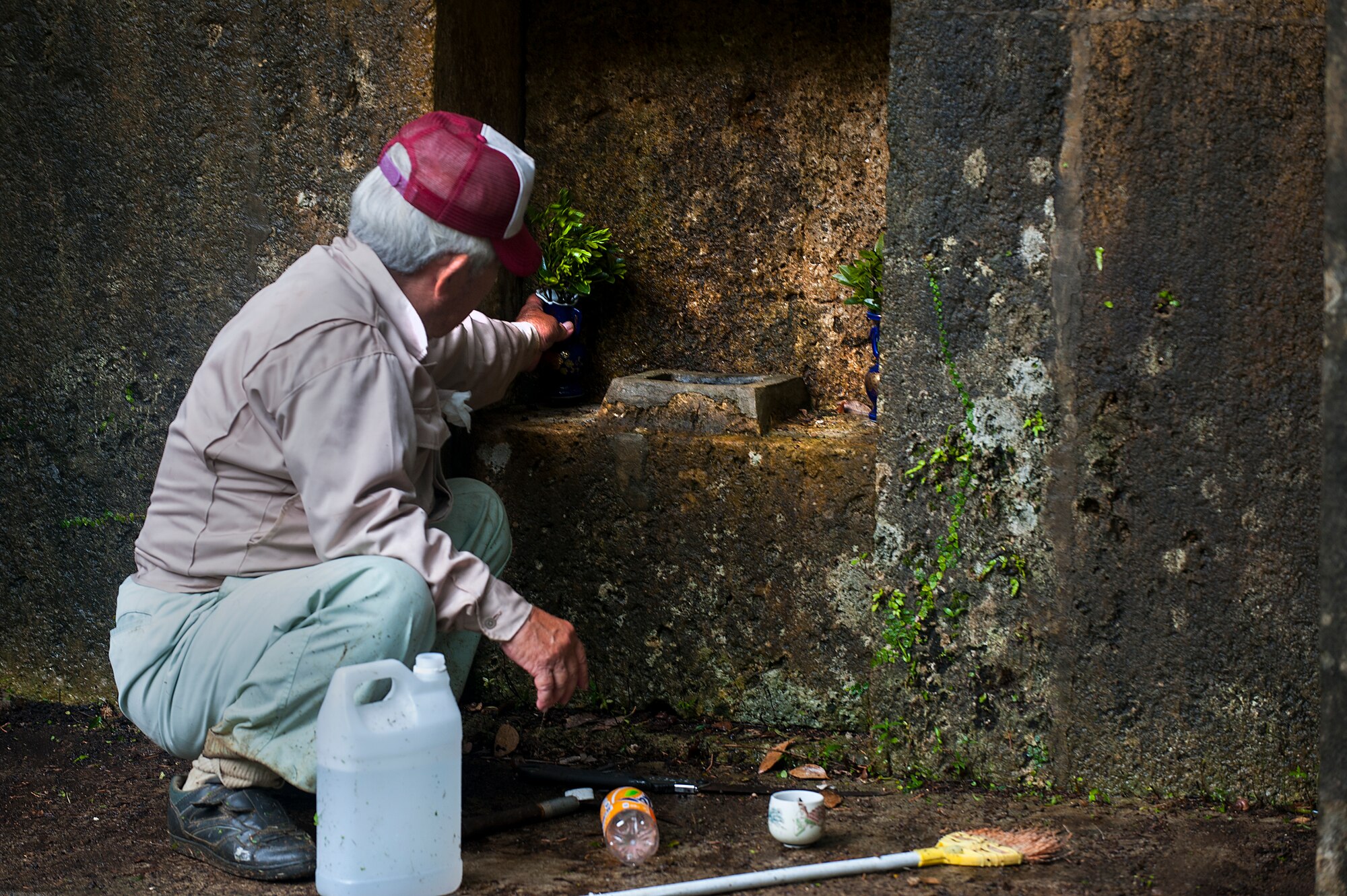 An Okinawan man prepares the tomb of his ancestors for the annual “Shimi” celebration April 10, 2016, at Kadena Air Base, Japan. “Shimi” is the time of year when Okinawan families come together to clean tombs, offer food and pray to their ancestors. (U.S. Air Force photo by Airman 1st Class Corey M. Pettis) 