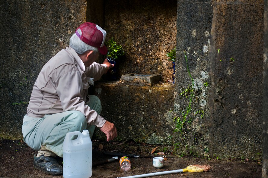 An Okinawan man prepares the tomb of his ancestors for the annual “Shimi” celebration April 10, 2016, at Kadena Air Base, Japan. “Shimi” is the time of year when Okinawan families come together to clean tombs, offer food and pray to their ancestors. (U.S. Air Force photo by Airman 1st Class Corey M. Pettis) 