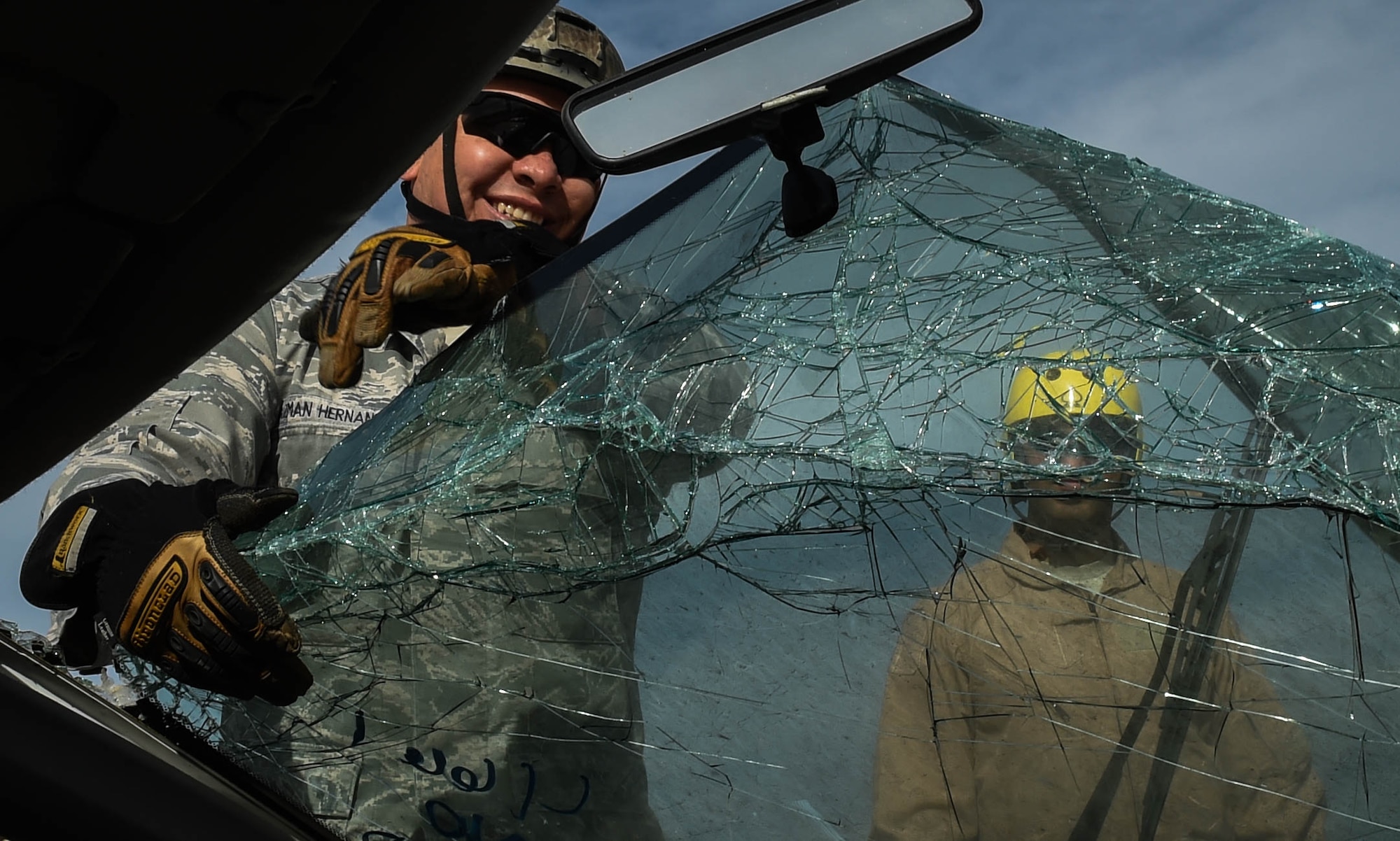 Tech. Sgt. Horacio Guzman Hernandez, 571st Mobility Support Advisory Squadron air advisor, pulls the windshield off the front of a vehicle to save a rescue dummy during vehicle extrication training April 7, 2016, at Travis Air Force Base, California. The Team Travis fire department worked with the 571st Mobility Support Advisory Squadron on vehicle extrication for future deployments to South and Central America. (U.S. Air Force photo by Staff  Sgt. Robert  Hicks/Released)      