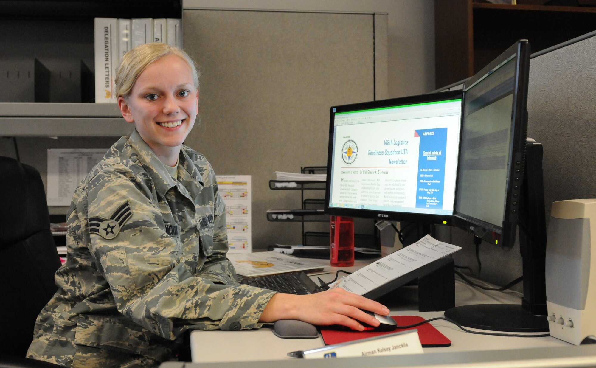 Senior Airman Kelsey Janckila poses for a photo at her desk at the 148th Fighter Wing April 10, 2016.  Janckila, a member of the logistics squadron command support staff, plans to graduate in the fall of 2016 with a degree in communications.  (U.S. Air National Guard Photo by Tech. Sgt. Scott G. Herrington/Released)