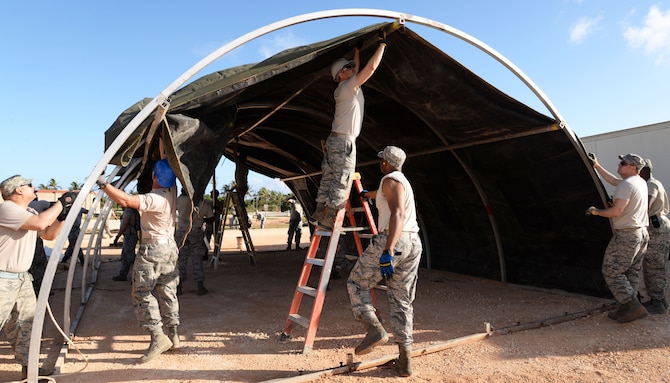 Members of the 175th Civil Engineering Squadron, Maryland Air National Guard, are constructing a tent to hold equipment in preparation for building a warehouse April 12, 2016 at Andersen Air Force Base, Guam. The 175th CES is the first of seven National Guard groups that will be working toward the completion of this project. (U. S. Air National Guard Photo by Airman 1st Class Enjoli Saunders/RELEASED)