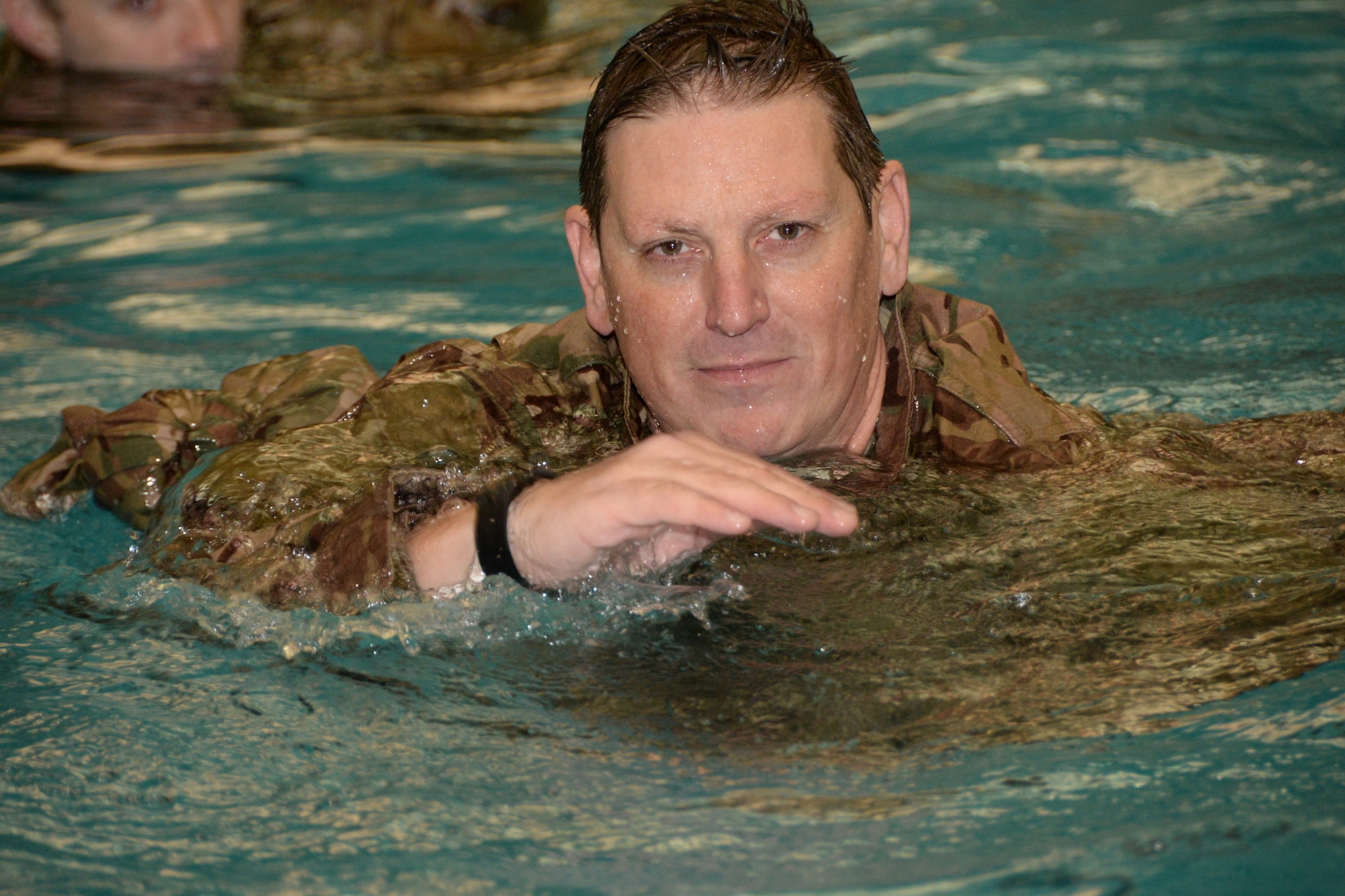 U.S. Air Force Lt. Col. Chris Snider, assigned to the Indiana Air National Guard, 181st Intelligence Wing, 113th Air Support Operations Squadron commander, practices using his uniform trousers as a flotation device during their combat water survival training at the Sports and Recreation Center on the campus of Rose-Hulman Institute of Technology in Terre Haute Feb. 6, 2016. (U.S. Air National Guard photo by Senior Airman Lonnie Wiram)