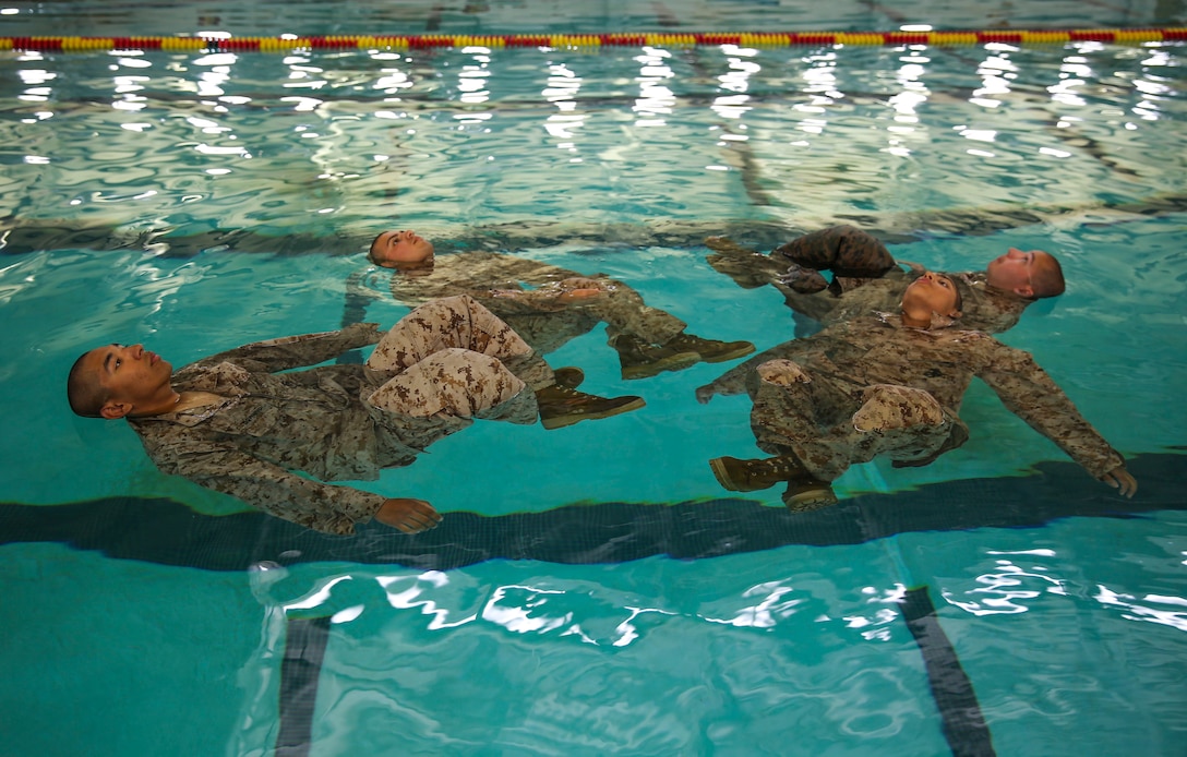 Recruits of Lima Company, 3rd Recruit Training Battalion, perform the four-minute water tread during the Water Survival Basic Qualification at Marine Corps Recruit Depot San Diego, April 11. Fear and lack of confidence caused some to become stressed and panicked, which made them forget the techniques they were taught. Annually, more than 17,000 males recruited from the Western Recruiting Region are trained at MCRD San Diego. Lima Company is scheduled to graduate June 10.