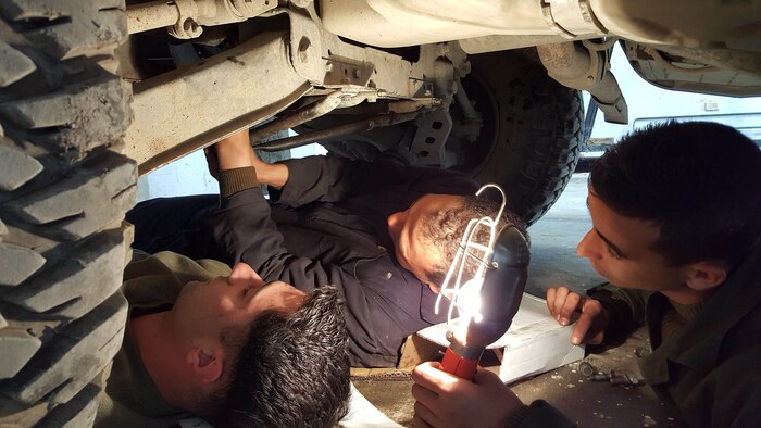 Sgt. Doug Lancie, a motor transportation mechanic, works with a Tunisian Groupement des Forces Speciales soldier during HMMWV maintenance training in Bizerte, Tunisia, Mar. 21- Apr. 8, 2016. The Marine vehicle maintenance and assistance team trained with the GFS to increase counter terrorism capabilities through motor transportation operations and maintenance training. 